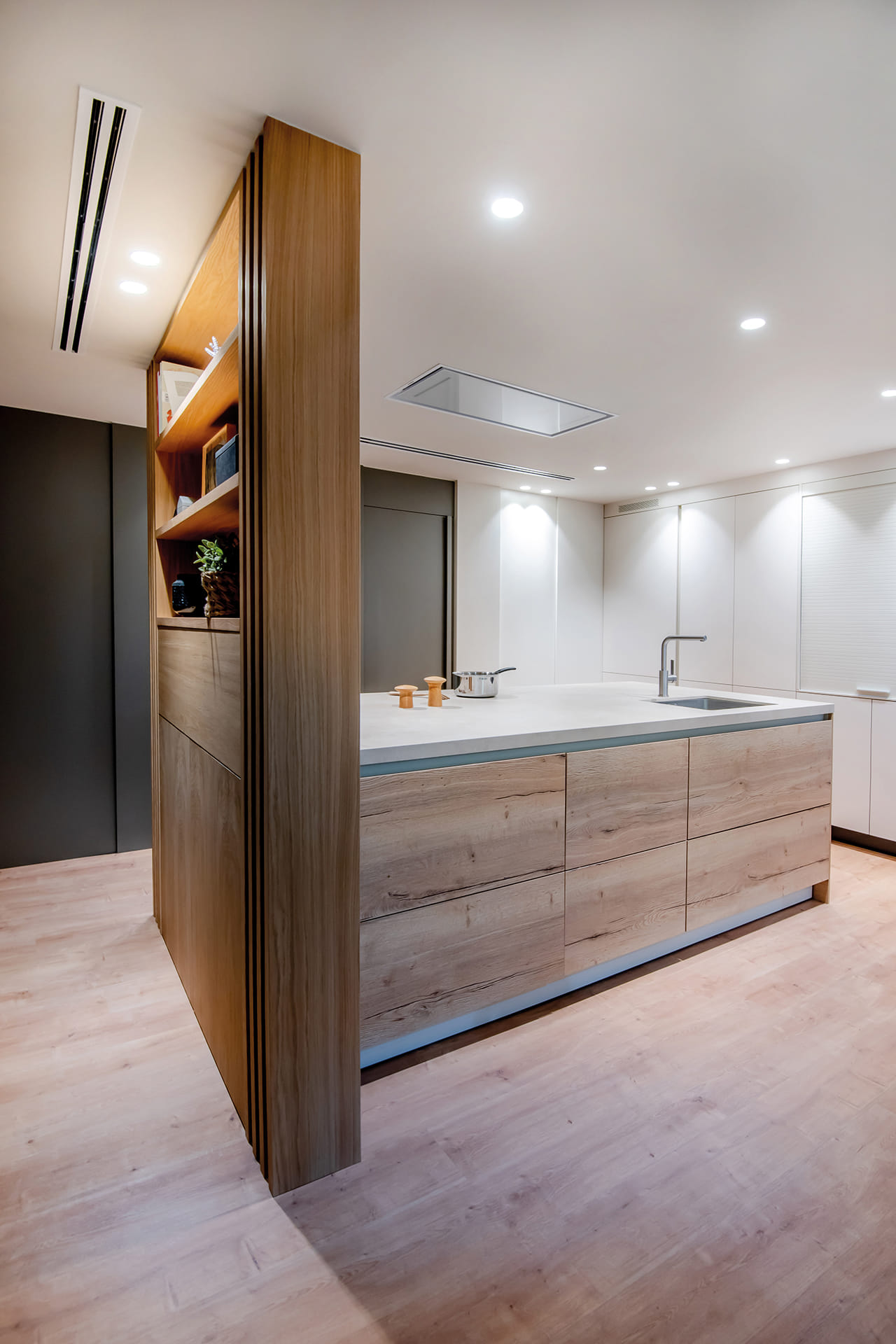 Open-plan kitchen with peninsula and wood