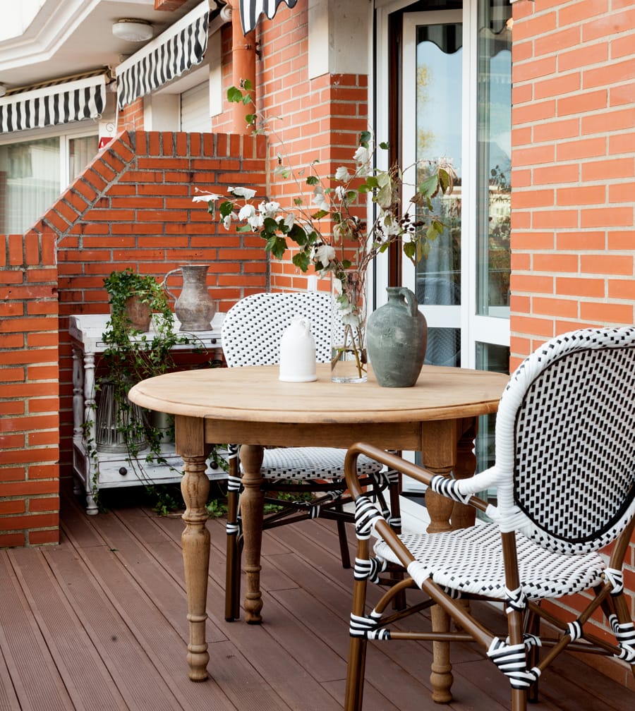 Outdoor terrace with fireplace, sofa and table