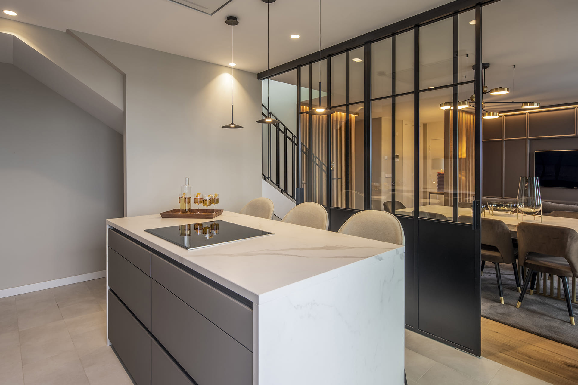 Island in a grey kitchen that opens out the living-dining room