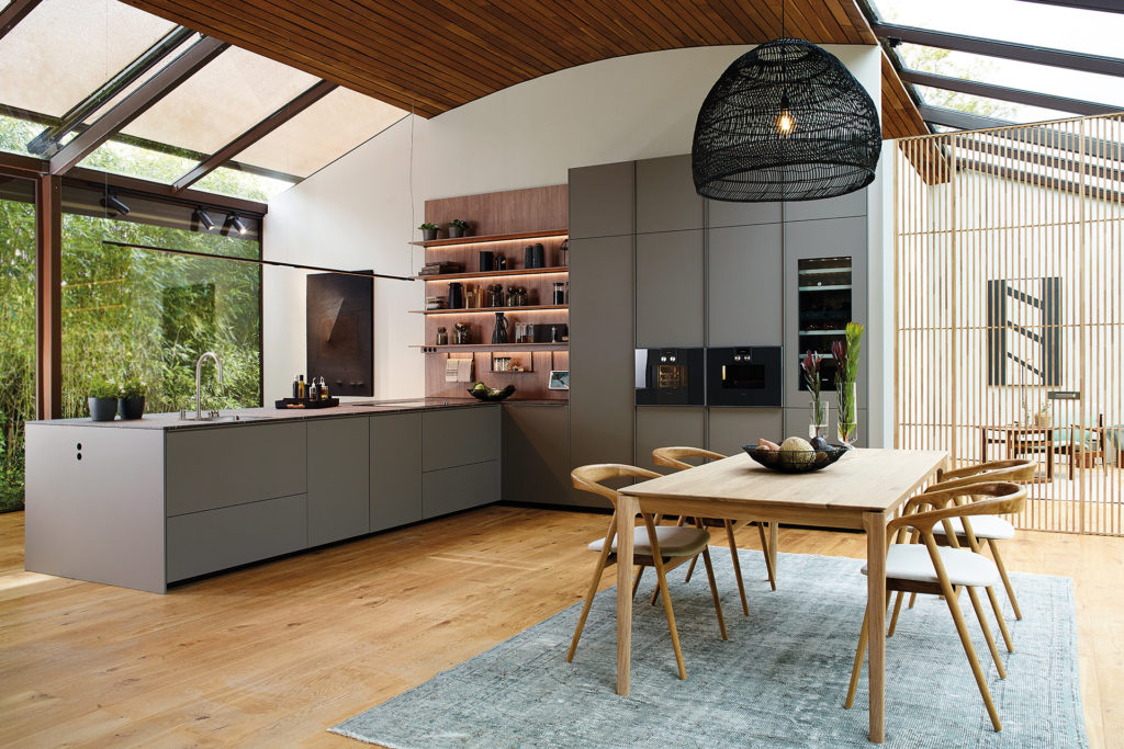 Cocina gris abierta con península y estantería