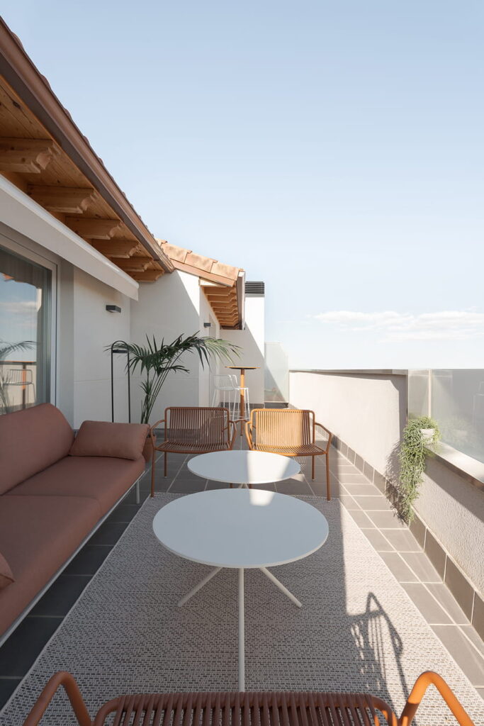 Large terrace with sofa and outdoor tables.