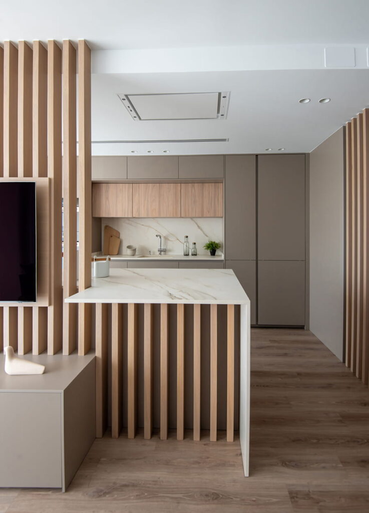 Sand grey kitchen with island and light elm slats.