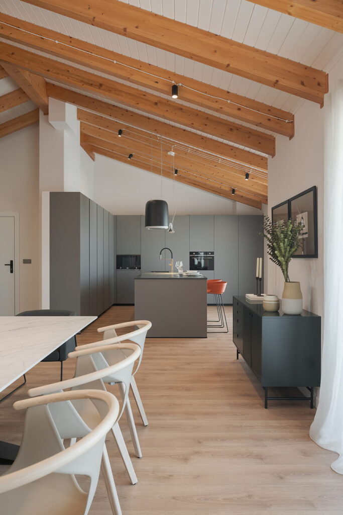 Grey kitchen with centre island open to the lounge/diner.