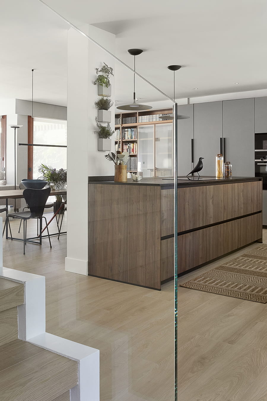 Grey kitchen with centre island open to the lounge, Santos design.