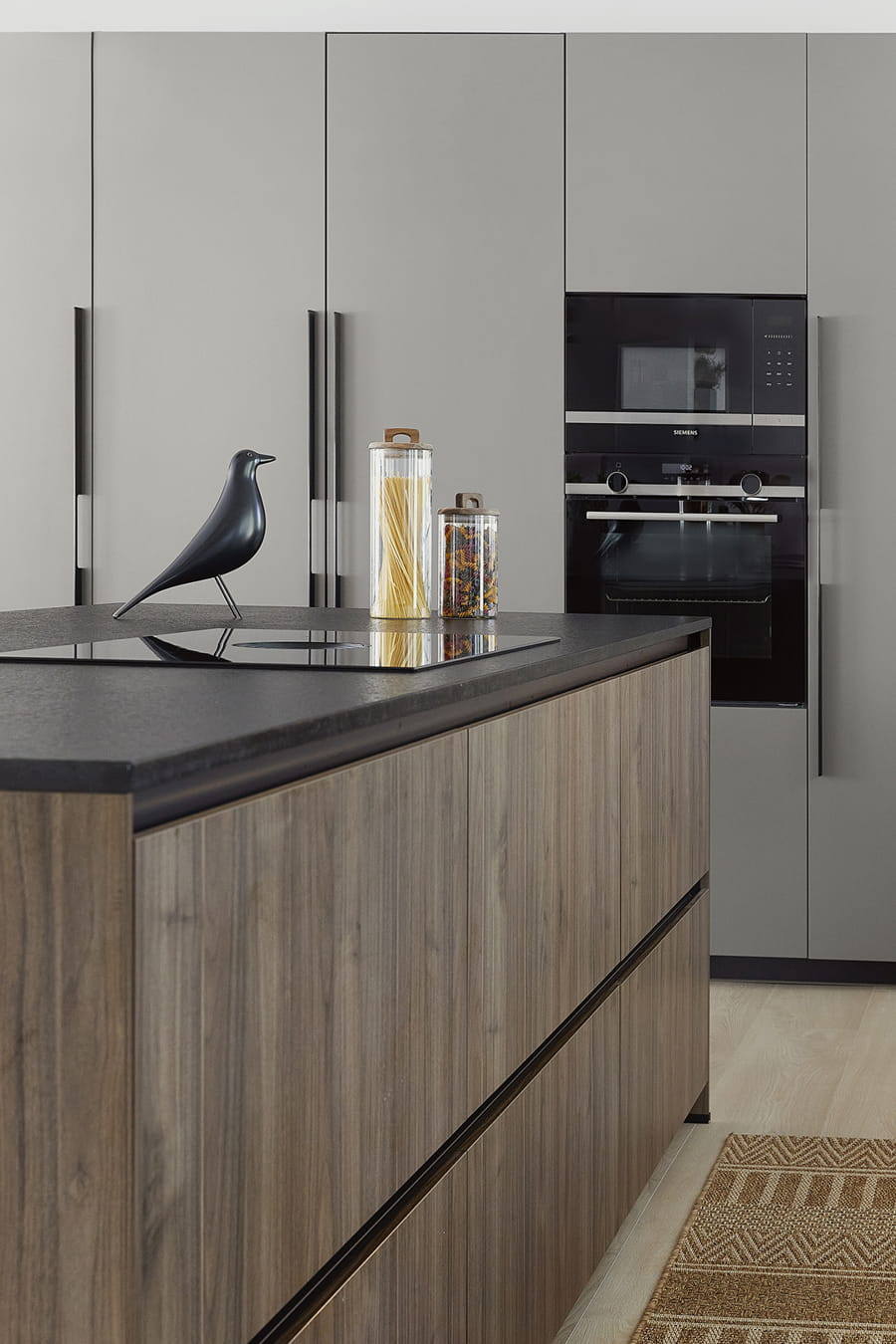 Grey kitchen with island clad in wood, design open to the lounge.