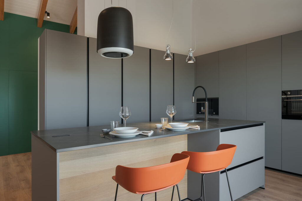 Grey and oak wood kitchen with centre island, design open to the lounge.