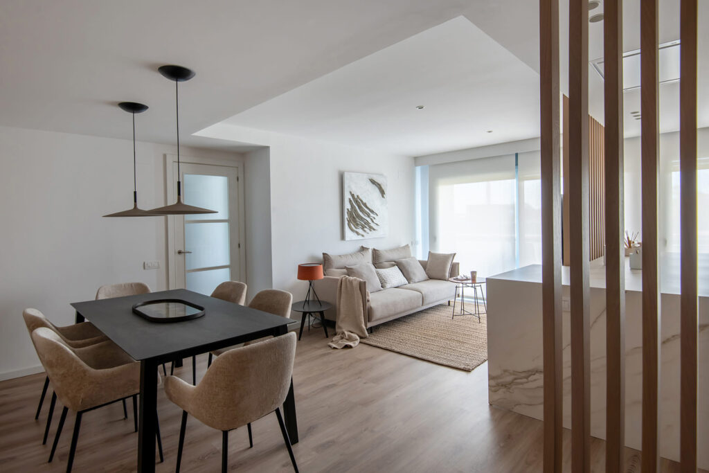 Lounge/diner with black table and stool, and sand grey chairs and armchairs.