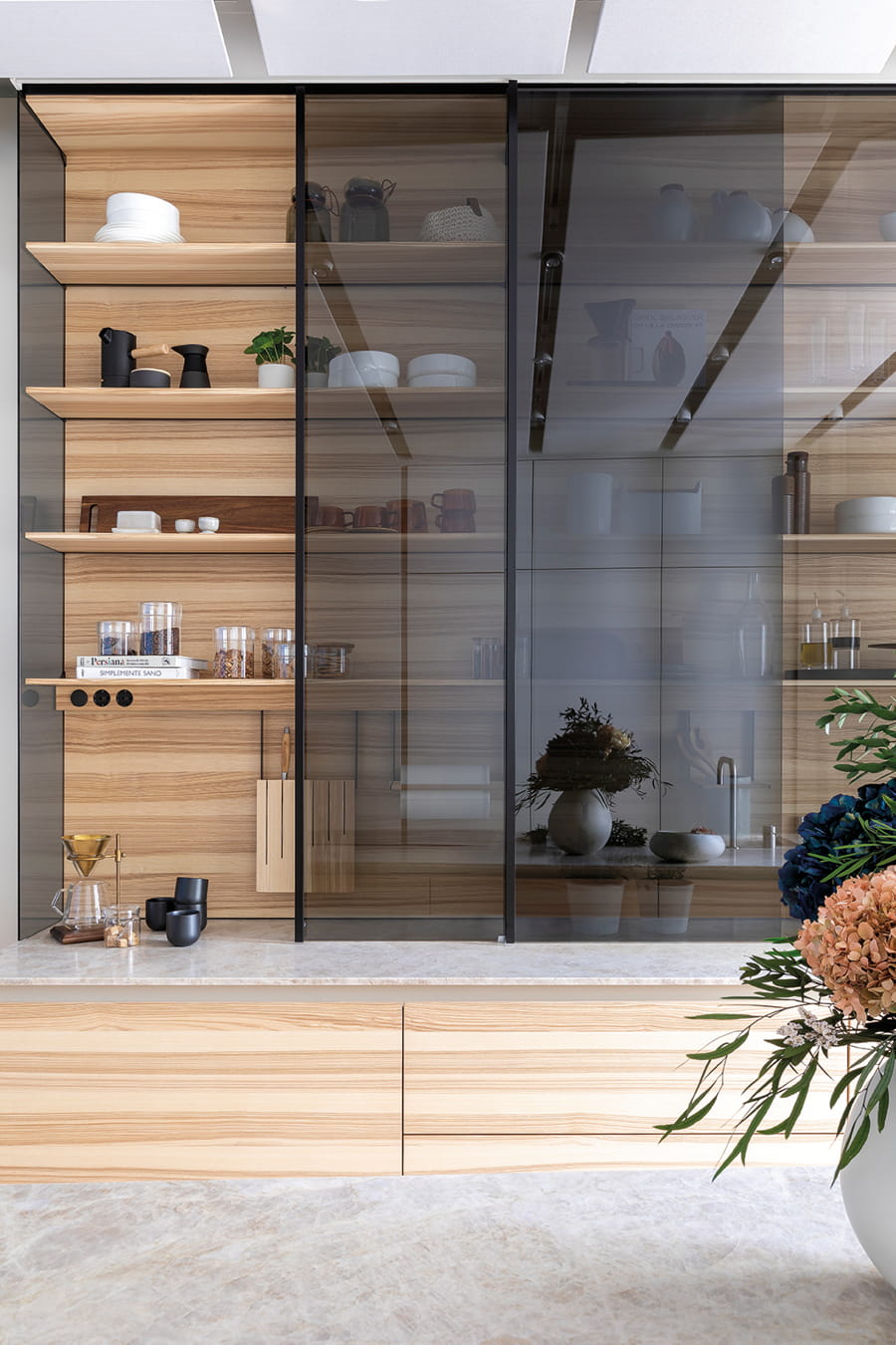 Sliding display cabinet with smoked glass in the Cocinas Santos space at Casa Decor.