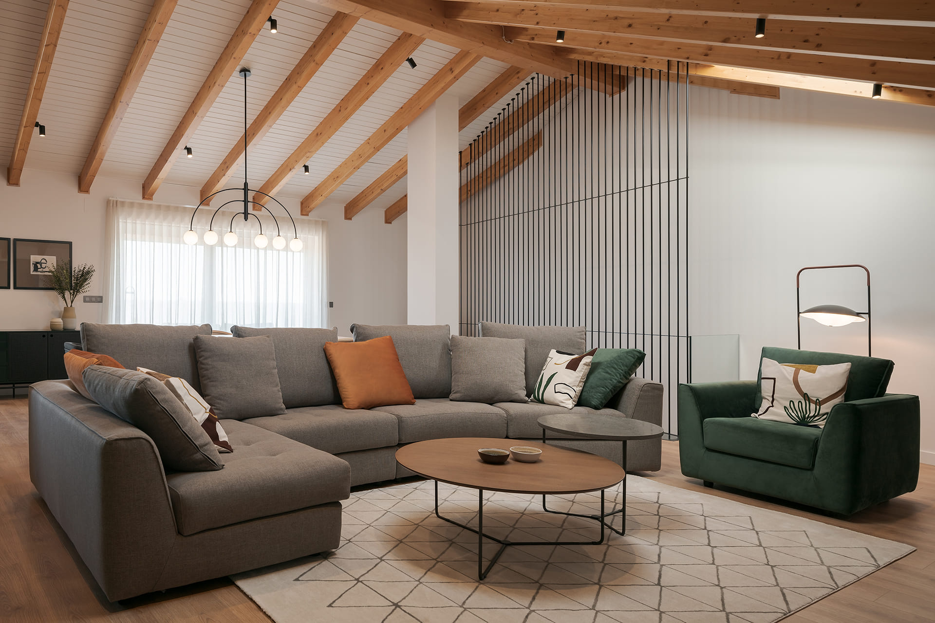 Lounge with curved Sofa and green armchair.