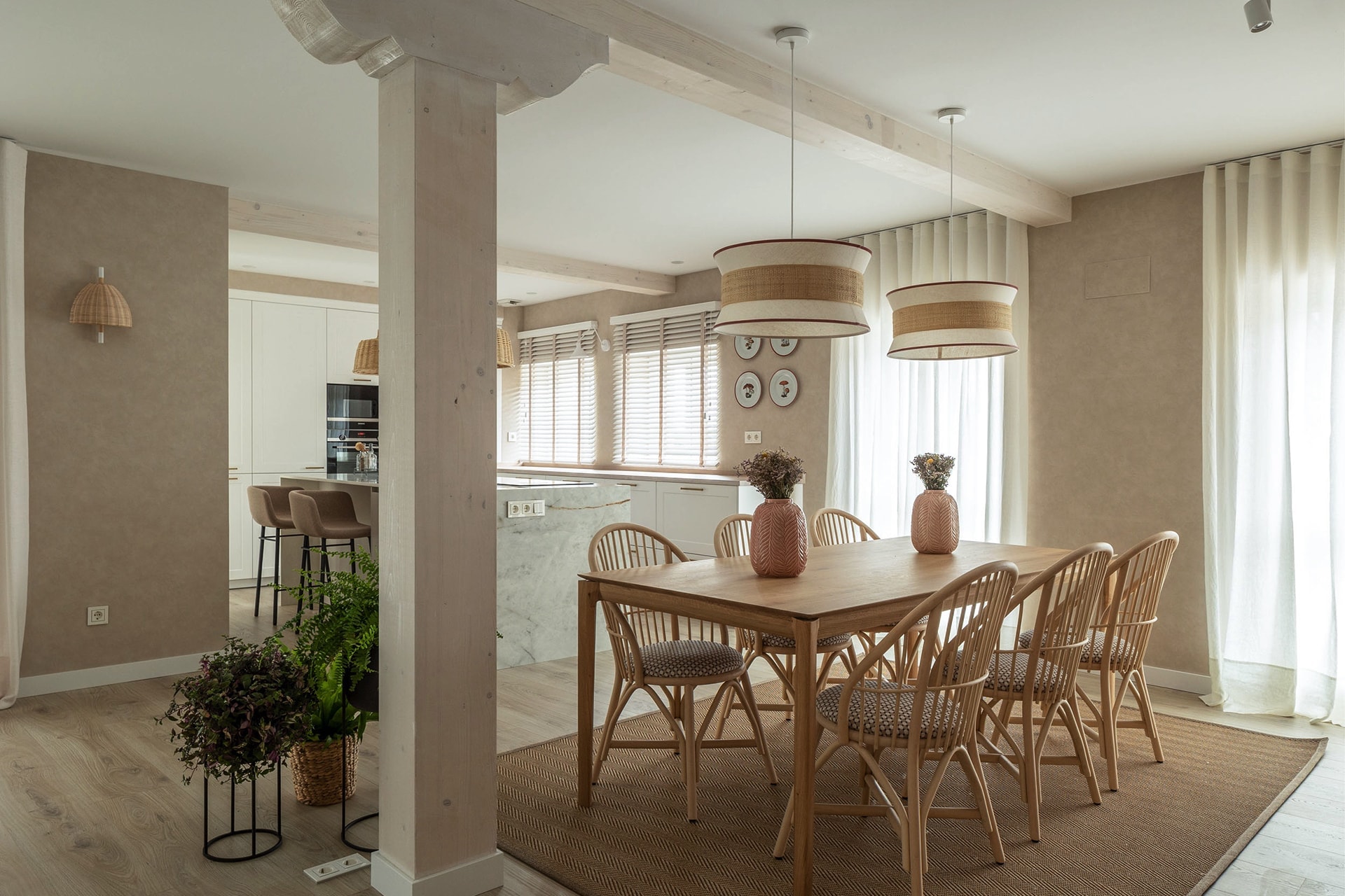 Kitchen open to the dining room in white and wood.
