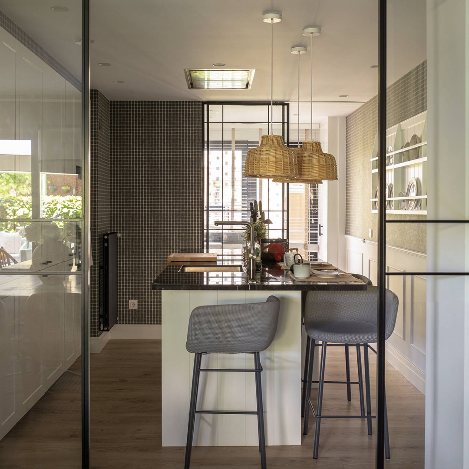 White kitchen with island and glazed enclosure.