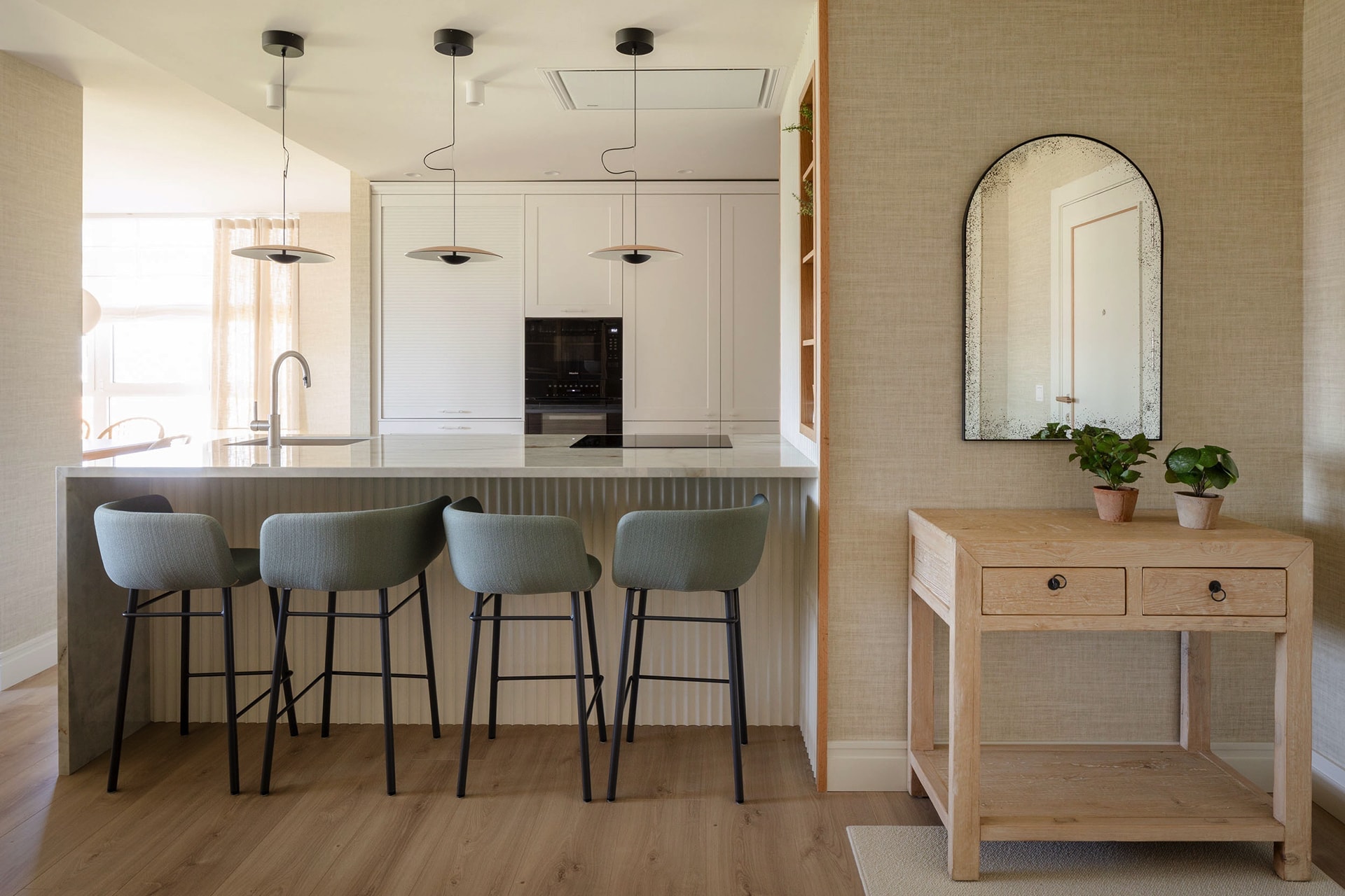 White and wood kitchen open to the daytime living area.
