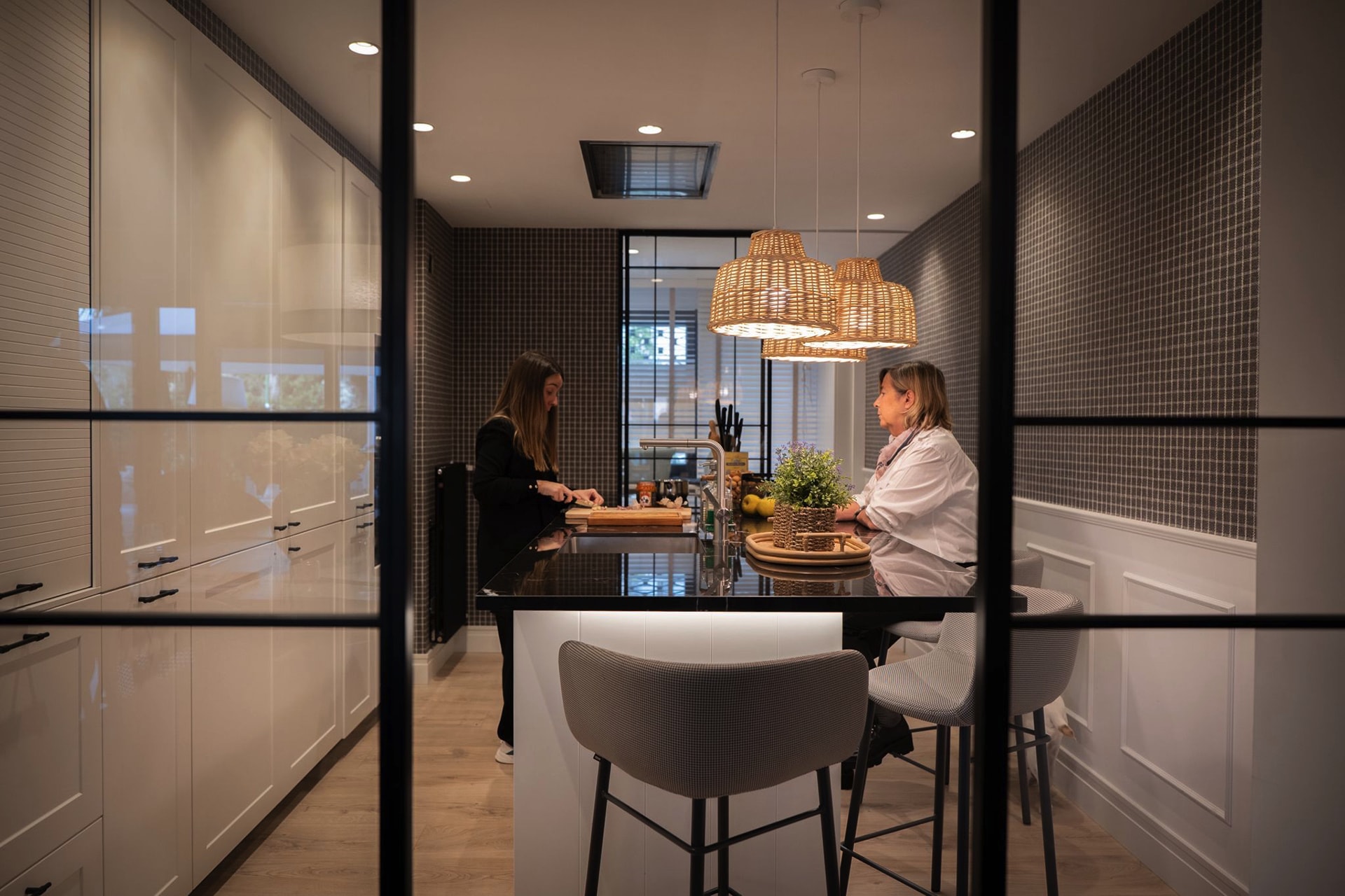 Parallel black and white kitchen with island.