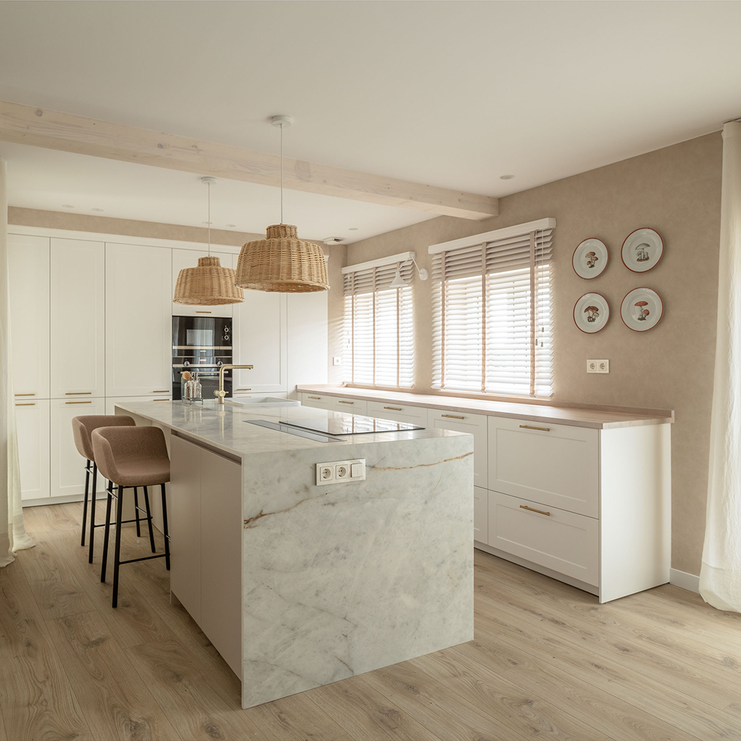 Kitchen with island and hanging lamps.