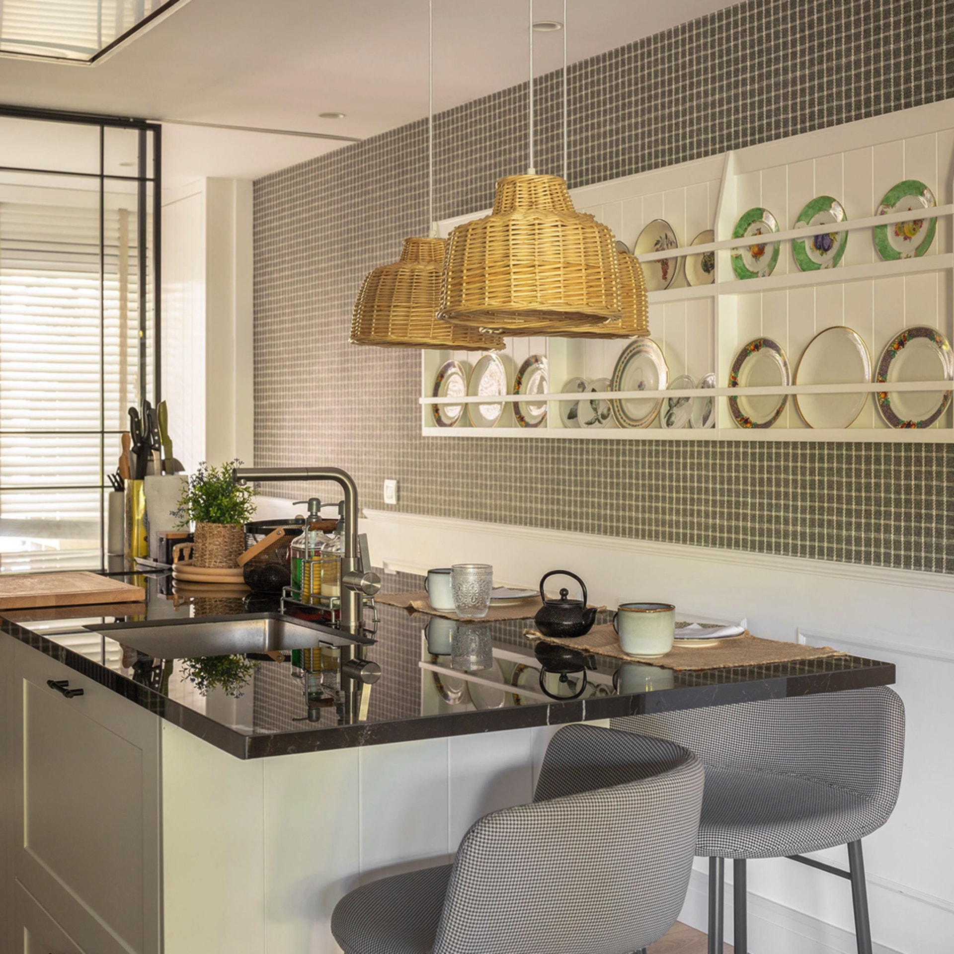 Black and white island with stools and hanging lamps.