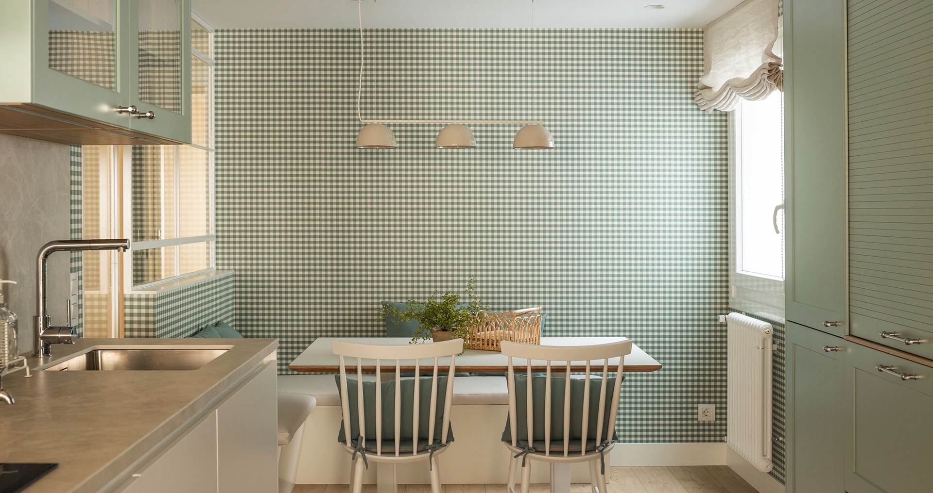 Kitchen table with hanging lamps, green kitchen.