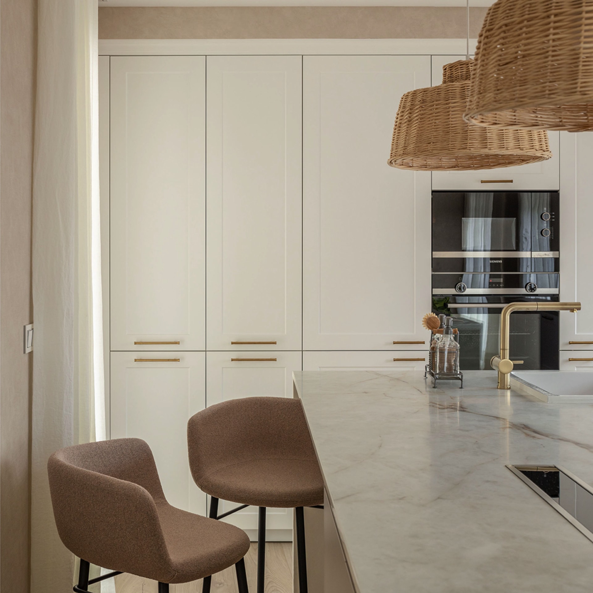 Stools on the island and tall kitchen units.