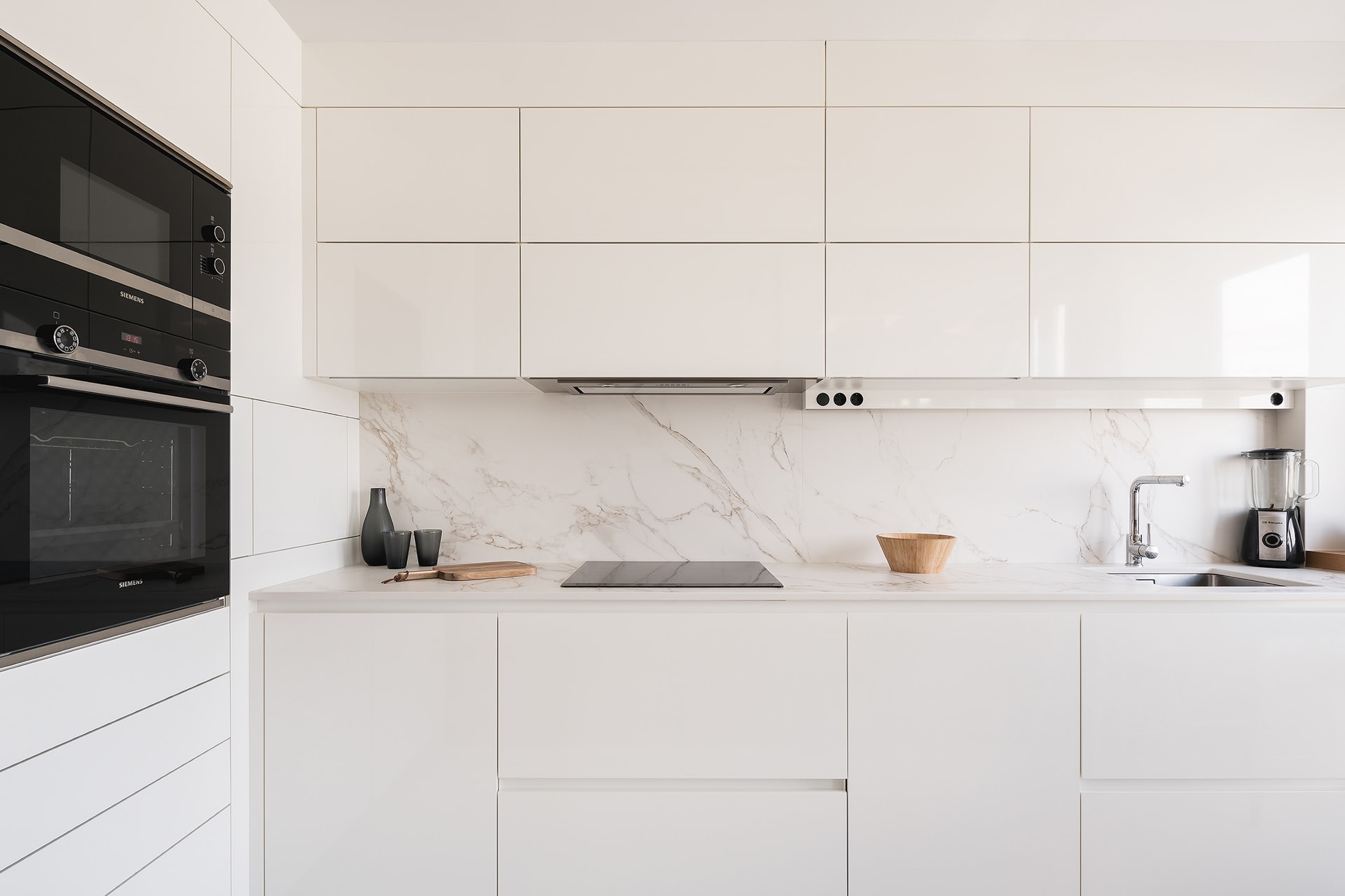 Cocina con mobiliario blanco Nata brillo de Santos abierta al comedor.