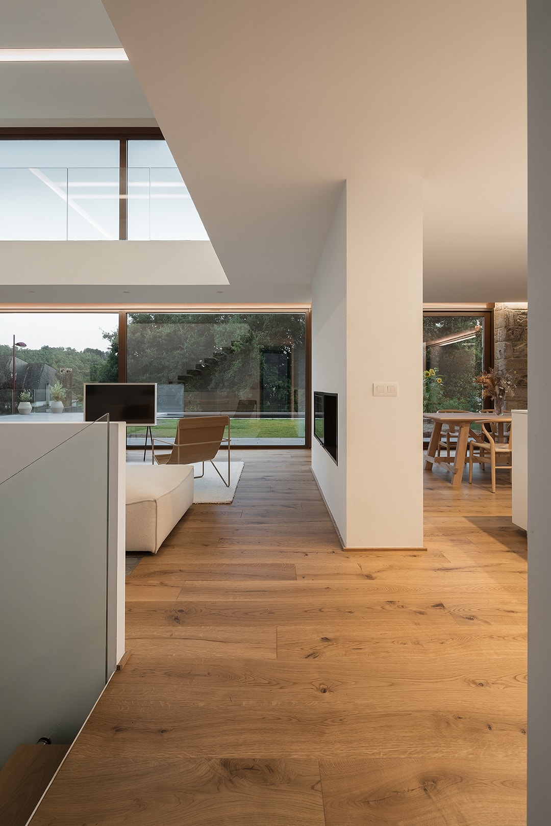 Vista lateral de cocina blanca Santos abierta al comedor, diseño de Arnela Arquitectura.