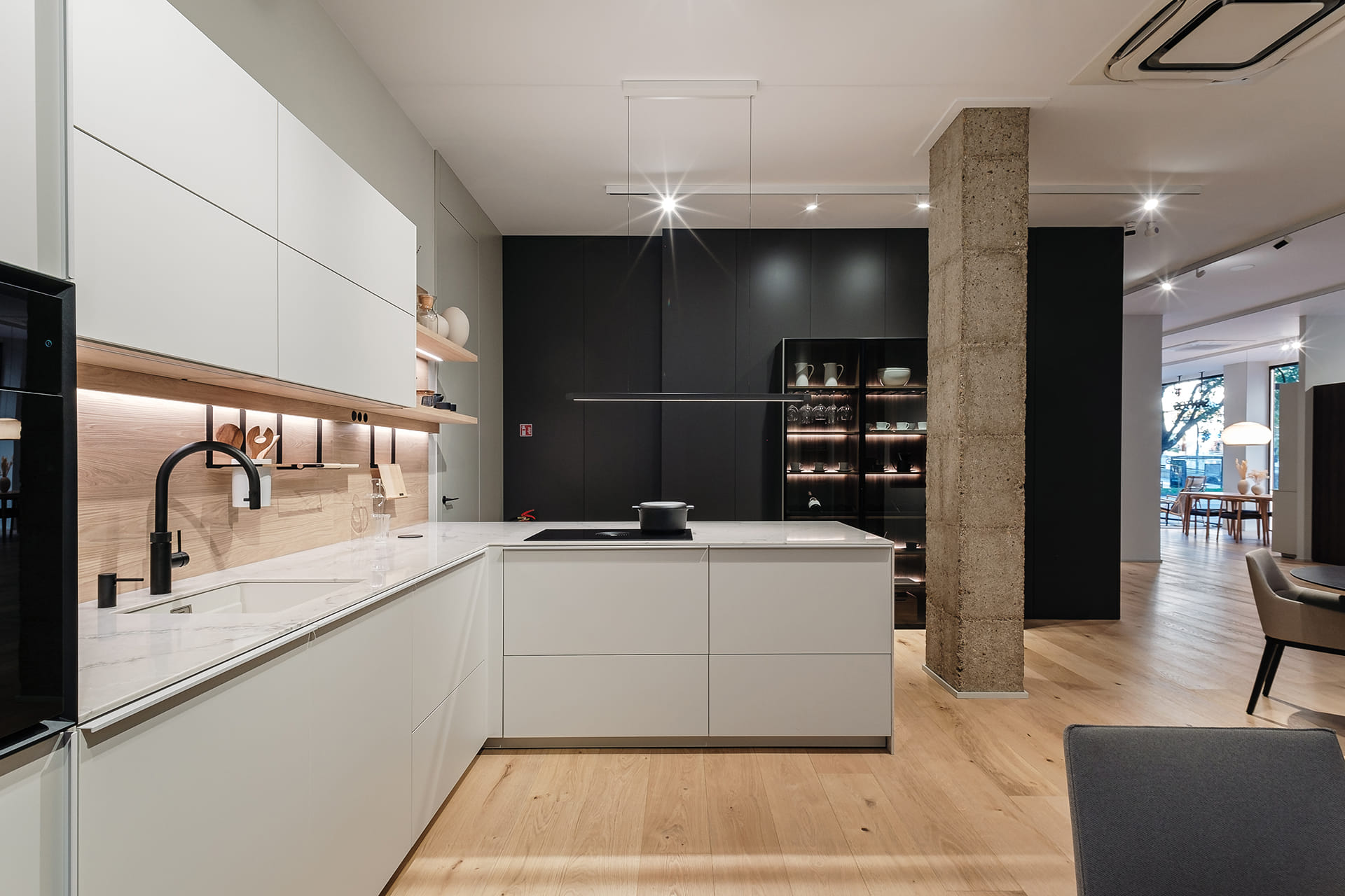 Cocina gris en L con acabados en madera en el nuevo shoroom de Cocinas FNDZ.