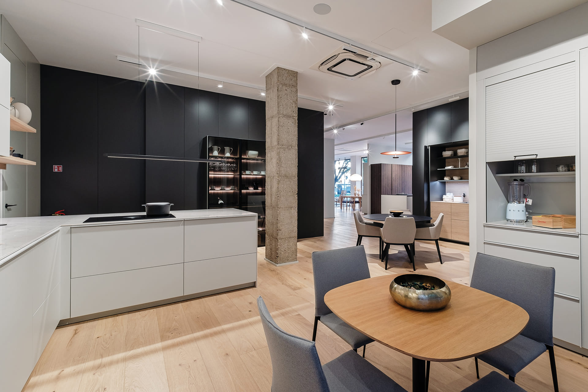 Cocina con península y lavandería anexa en la tienda de Cocinas Santos en Murcia.
