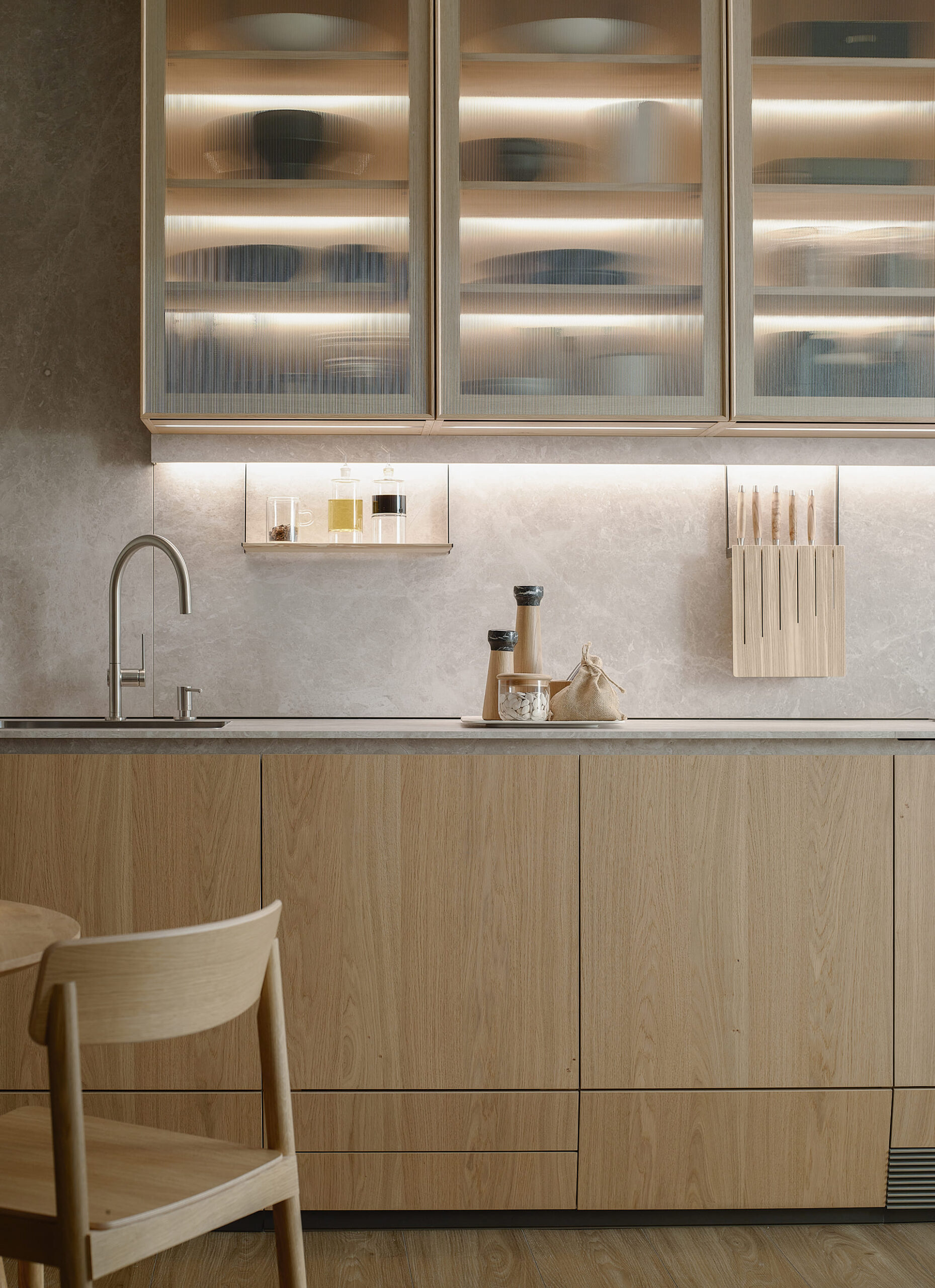 Vista frontal de una cocina en color madera y panel laminado acabado Cuarcita Crema diseñada por Santos.
