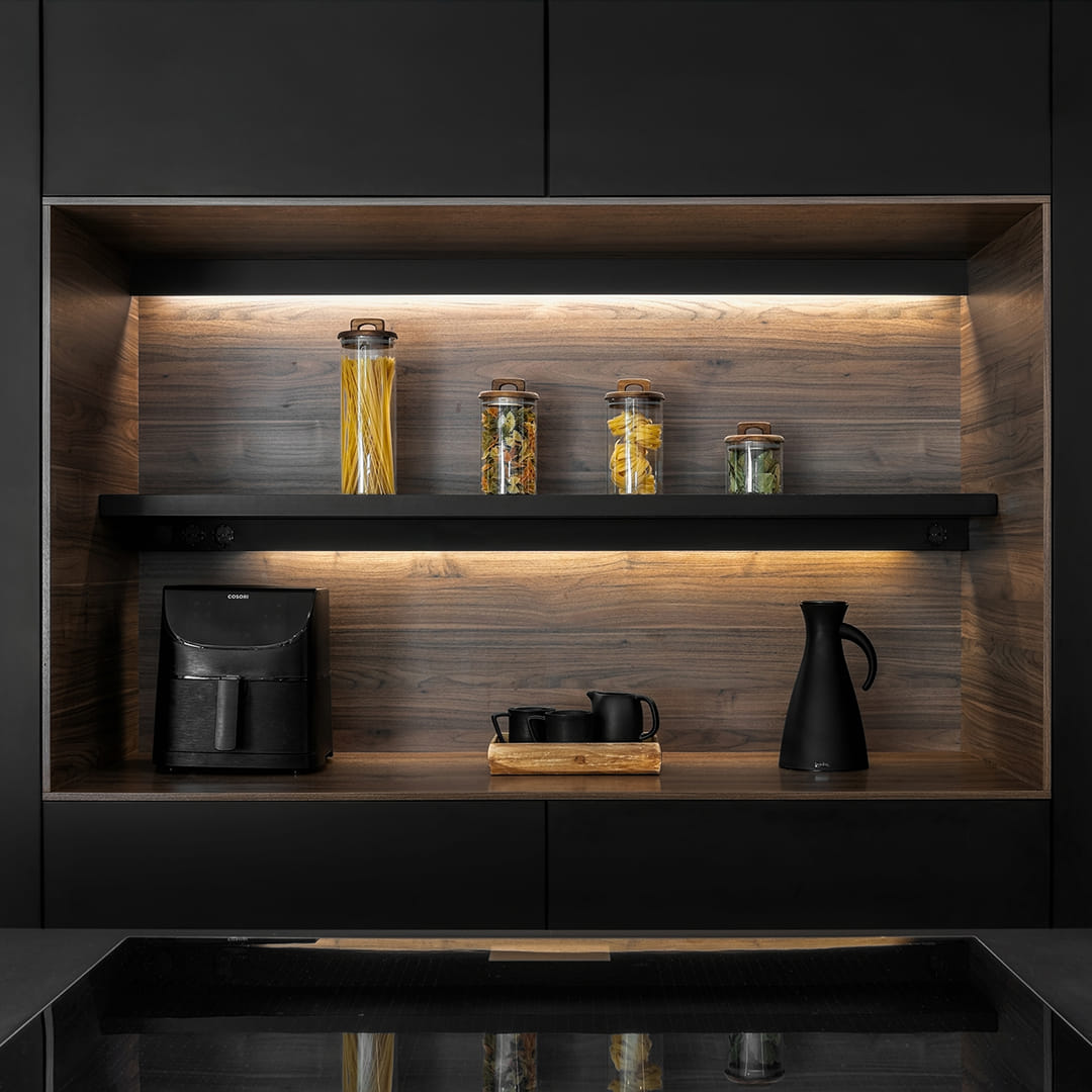 Close-up of cabinet in Earth Walnut in a black and wood kitchen designed by Santos Kitchens.
