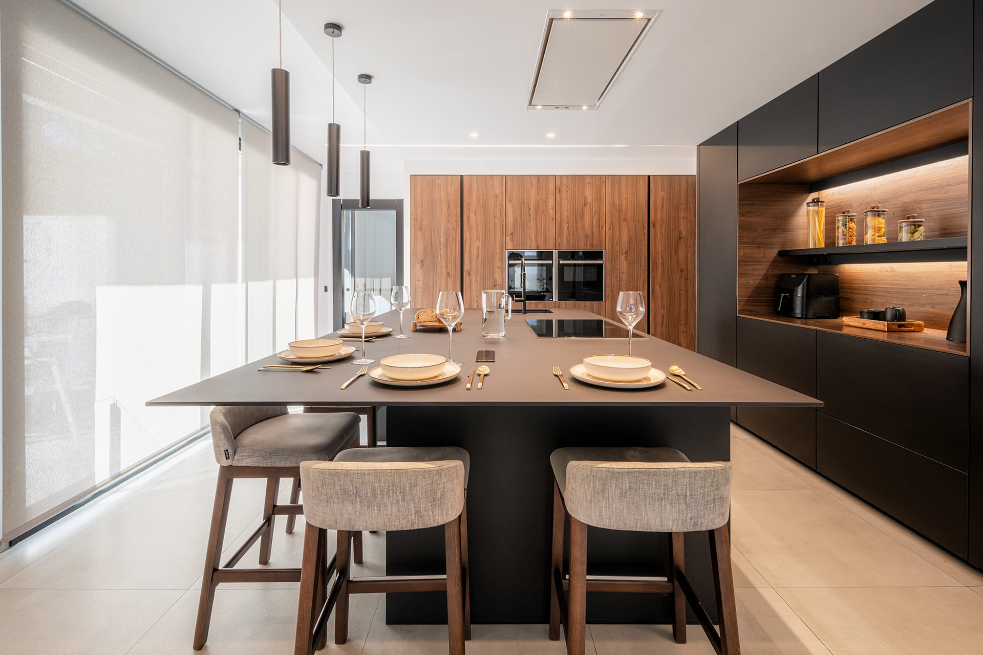 Black and wood kitchen with centre island designed by Santos Kitchens in a renovated house.