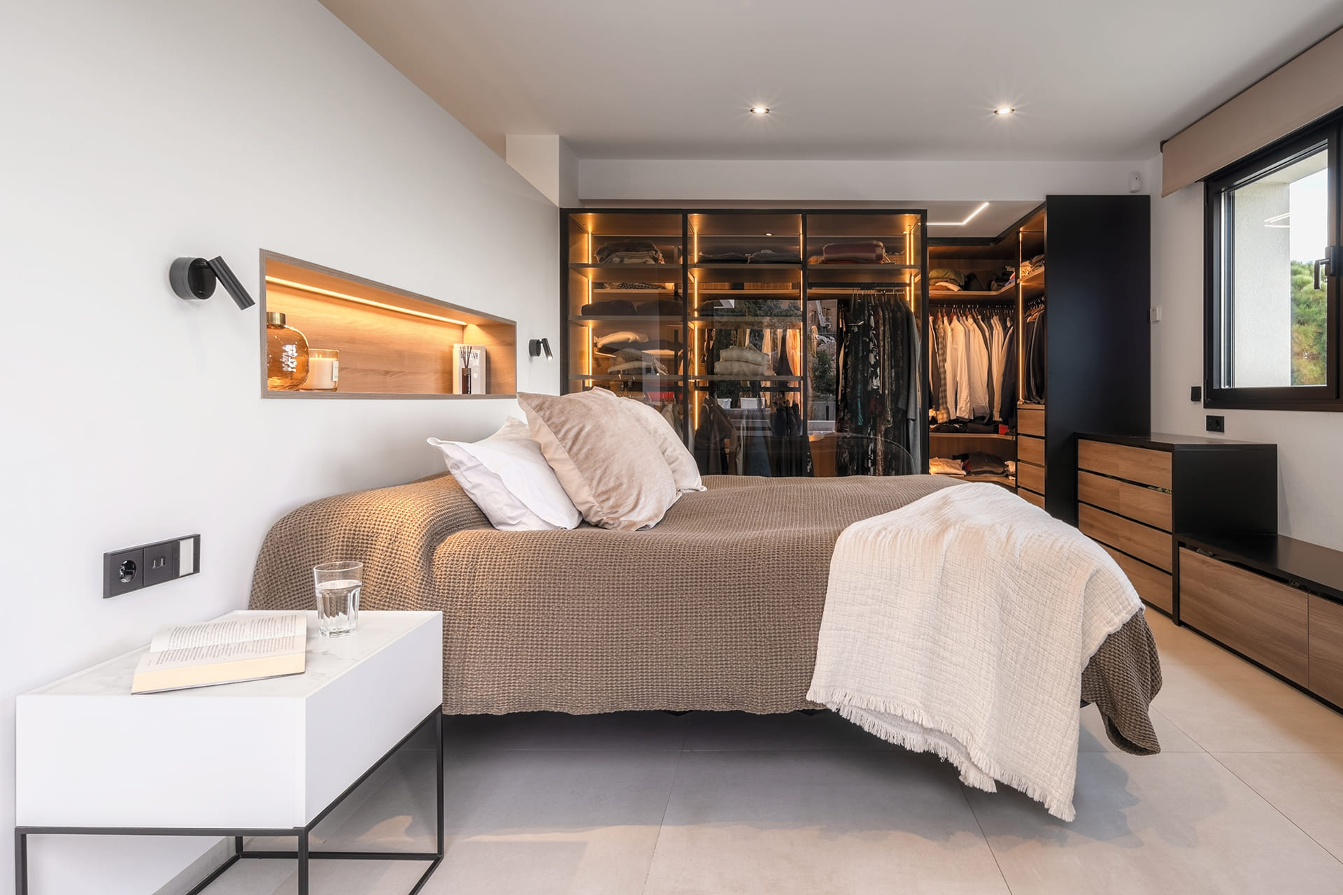 Bedroom with dressing room in a detached house with a Santos kitchen.