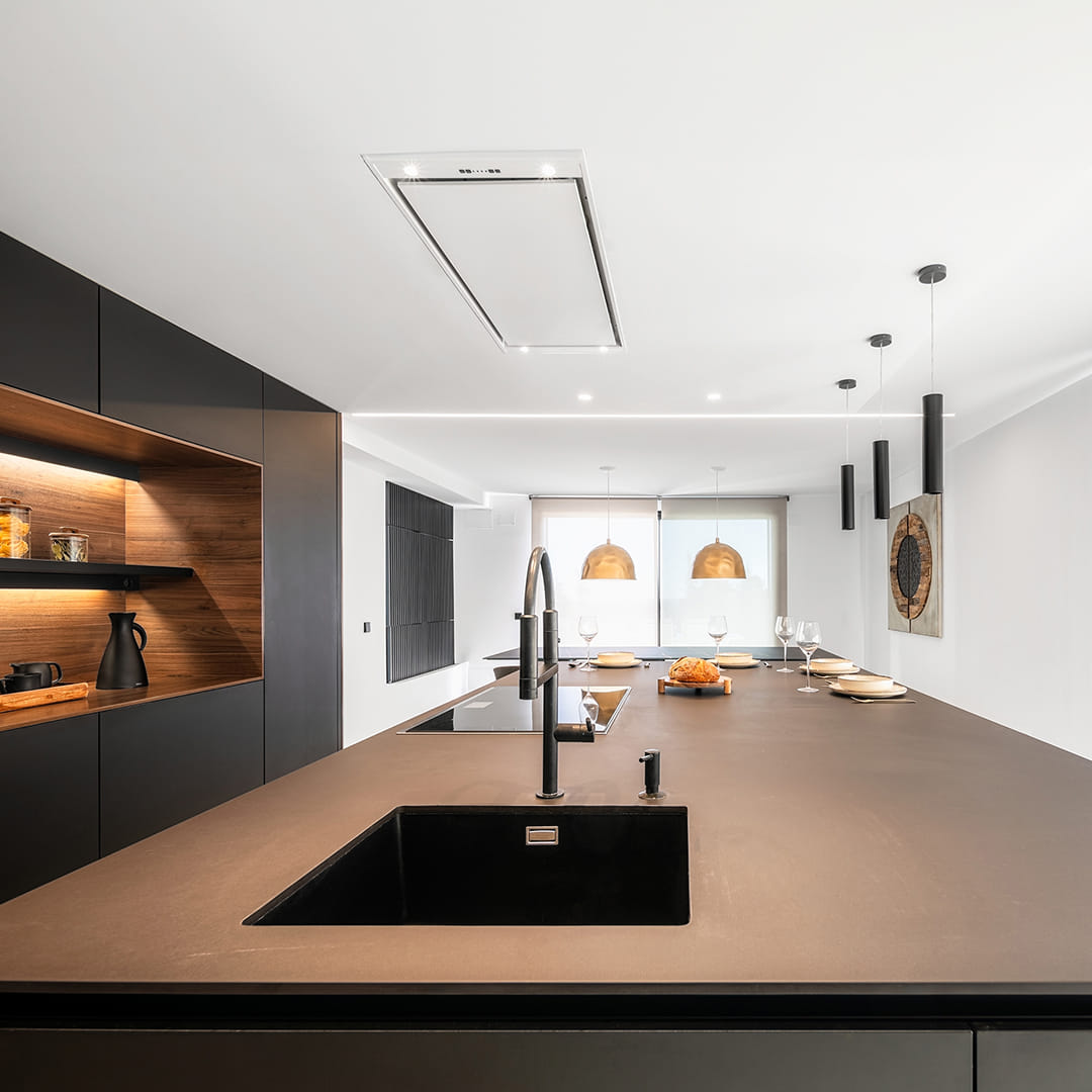 Black sink in a black and wood kitchen designed by Santos Kitchens.