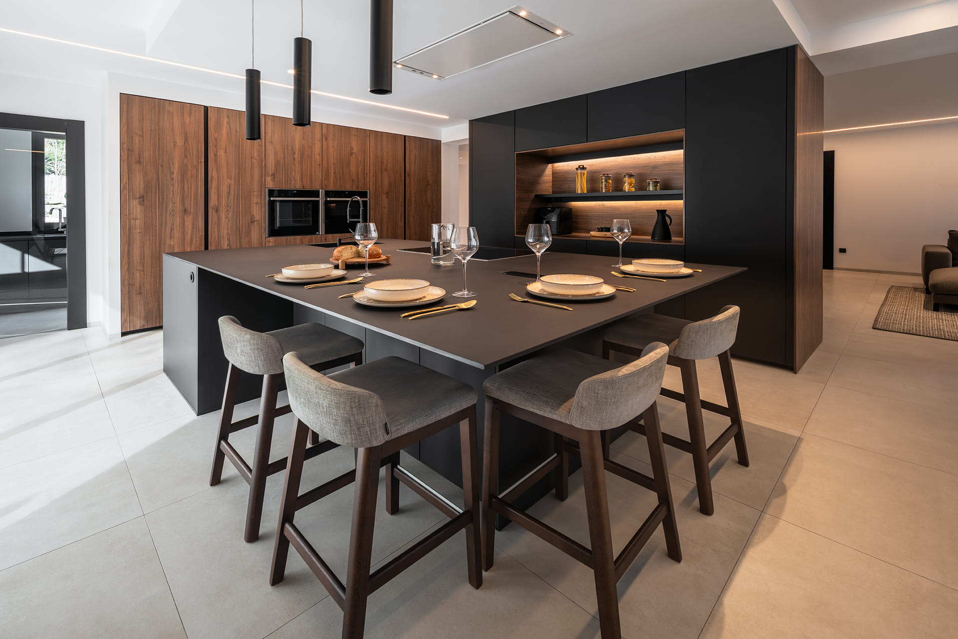 Black kitchen island with breakfast bar in a kitchen designed by Santos.