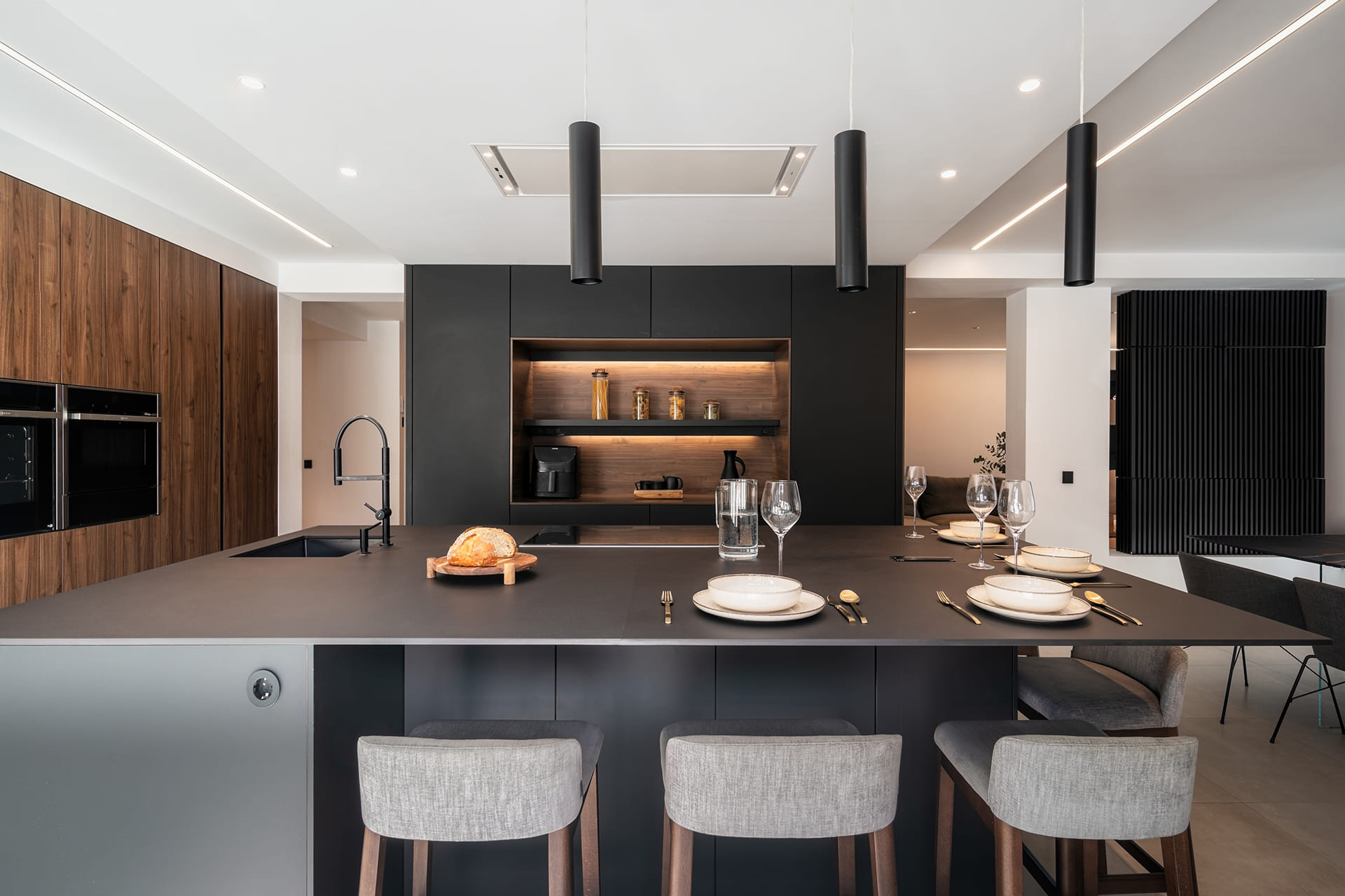 View of the black kitchen island with counter in a Santos kitchen.