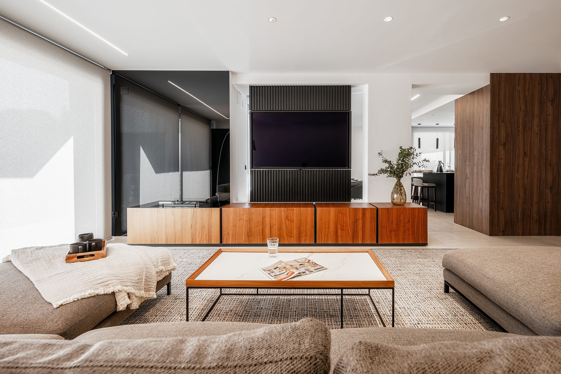 View of the lounge and the Santos kitchen in the background in a renovated house.