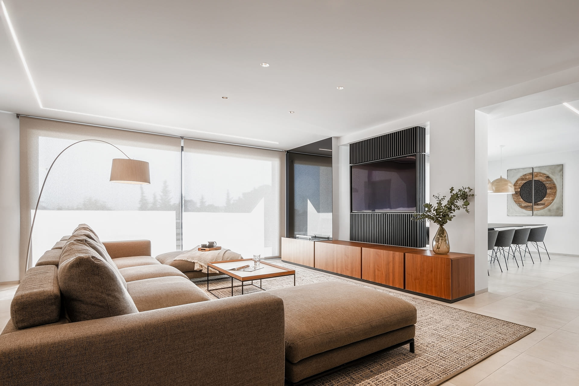 View of the lounge with sofa and the diner in the background in a renovated house with a Santos kitchen.
