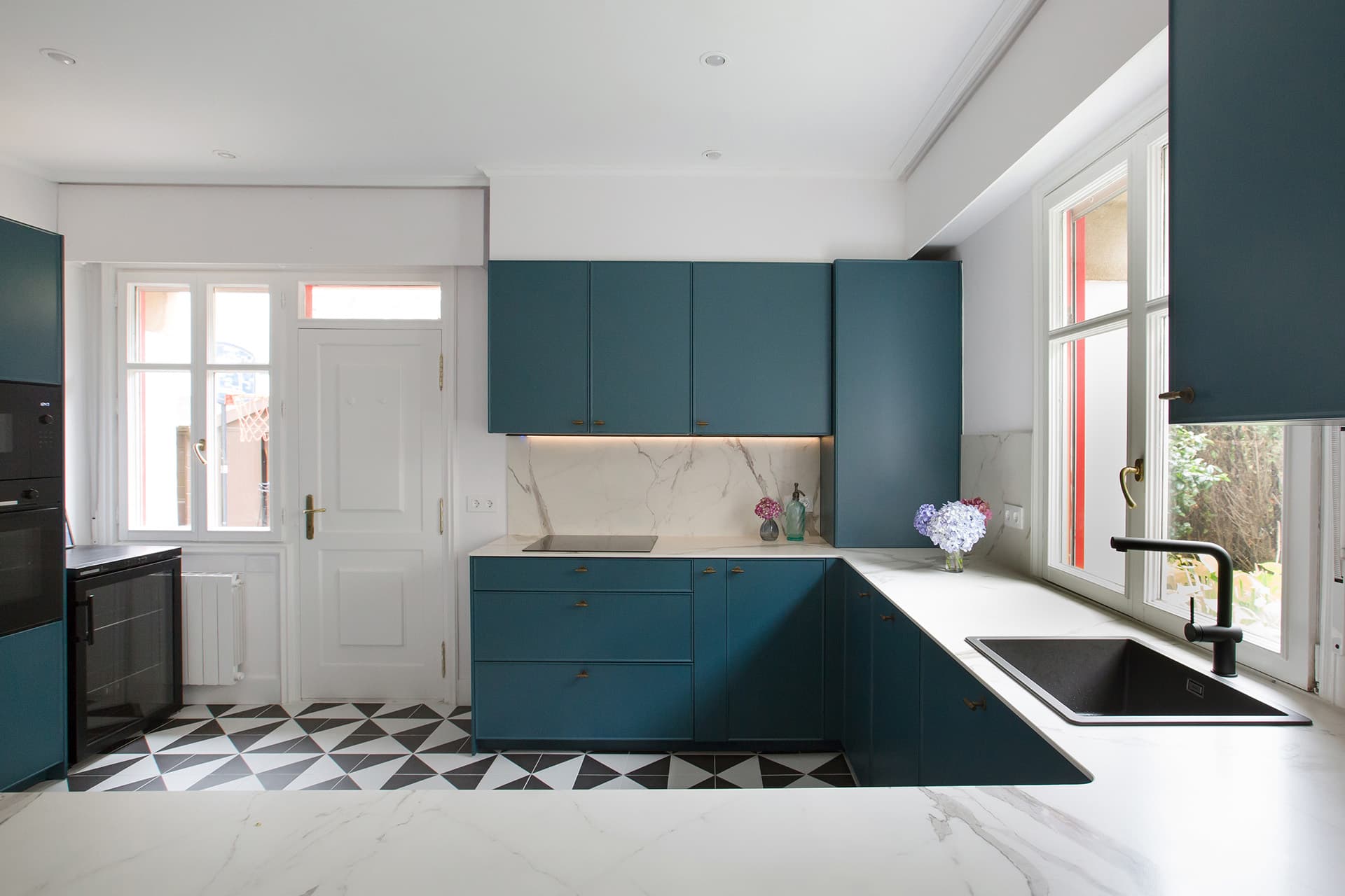 Blue kitchen cabinets in a kitchen designed by Santos Kitchens.