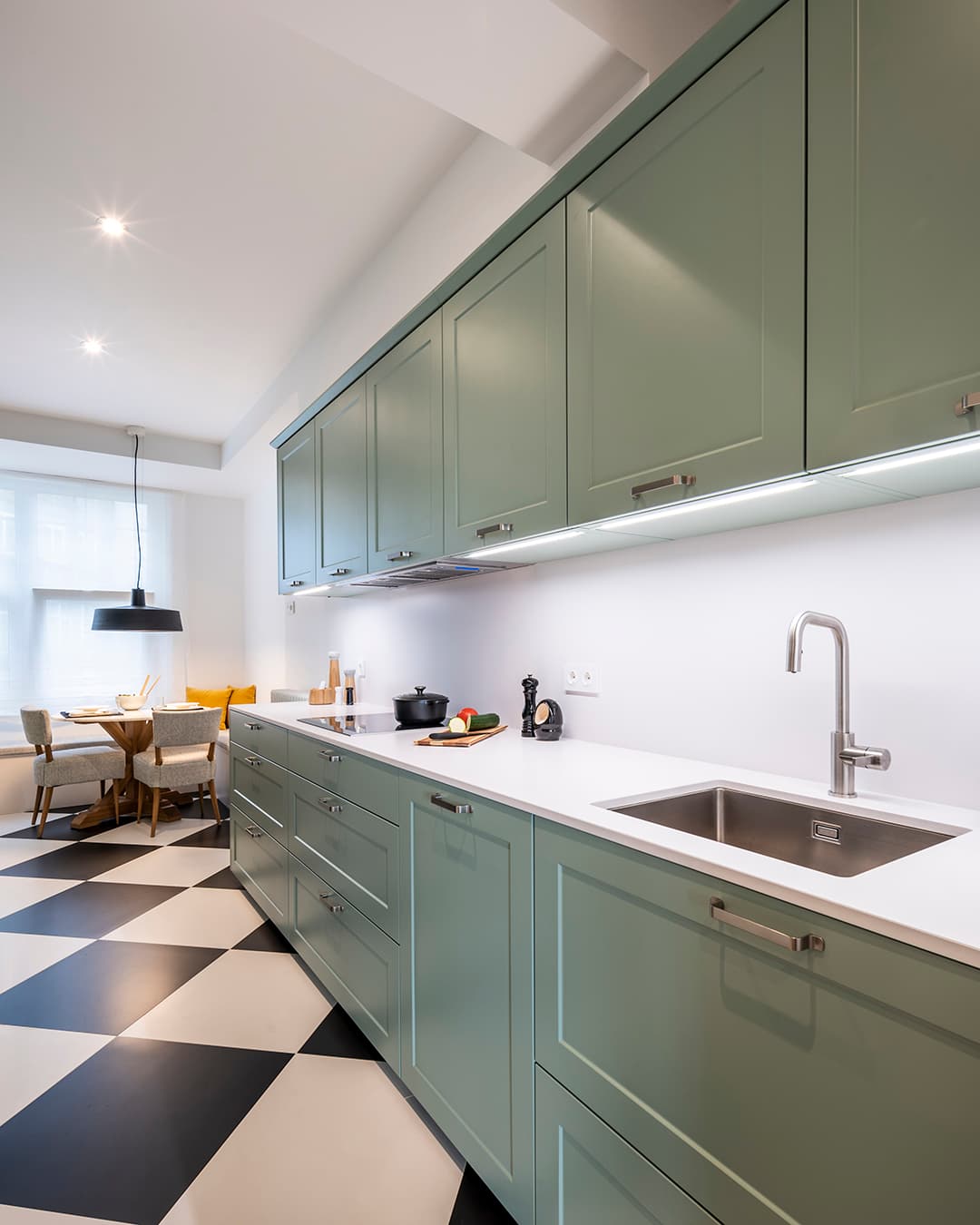 Green kitchen cabinets in a Sage Green Silk Matt kitchen designed by Santos Kitchens.