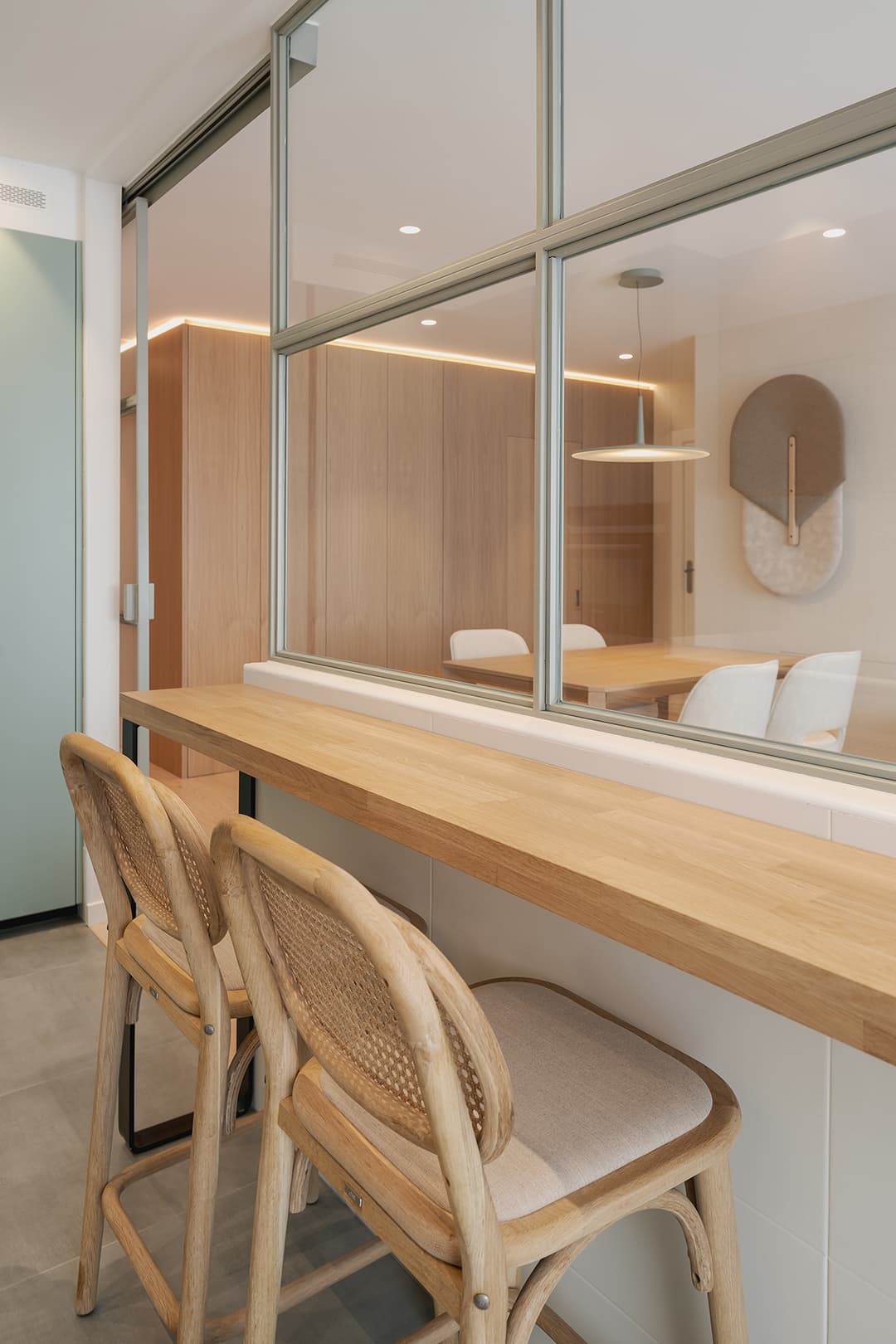 Wood counter in a green kitchen designed by Santos Kitchens.