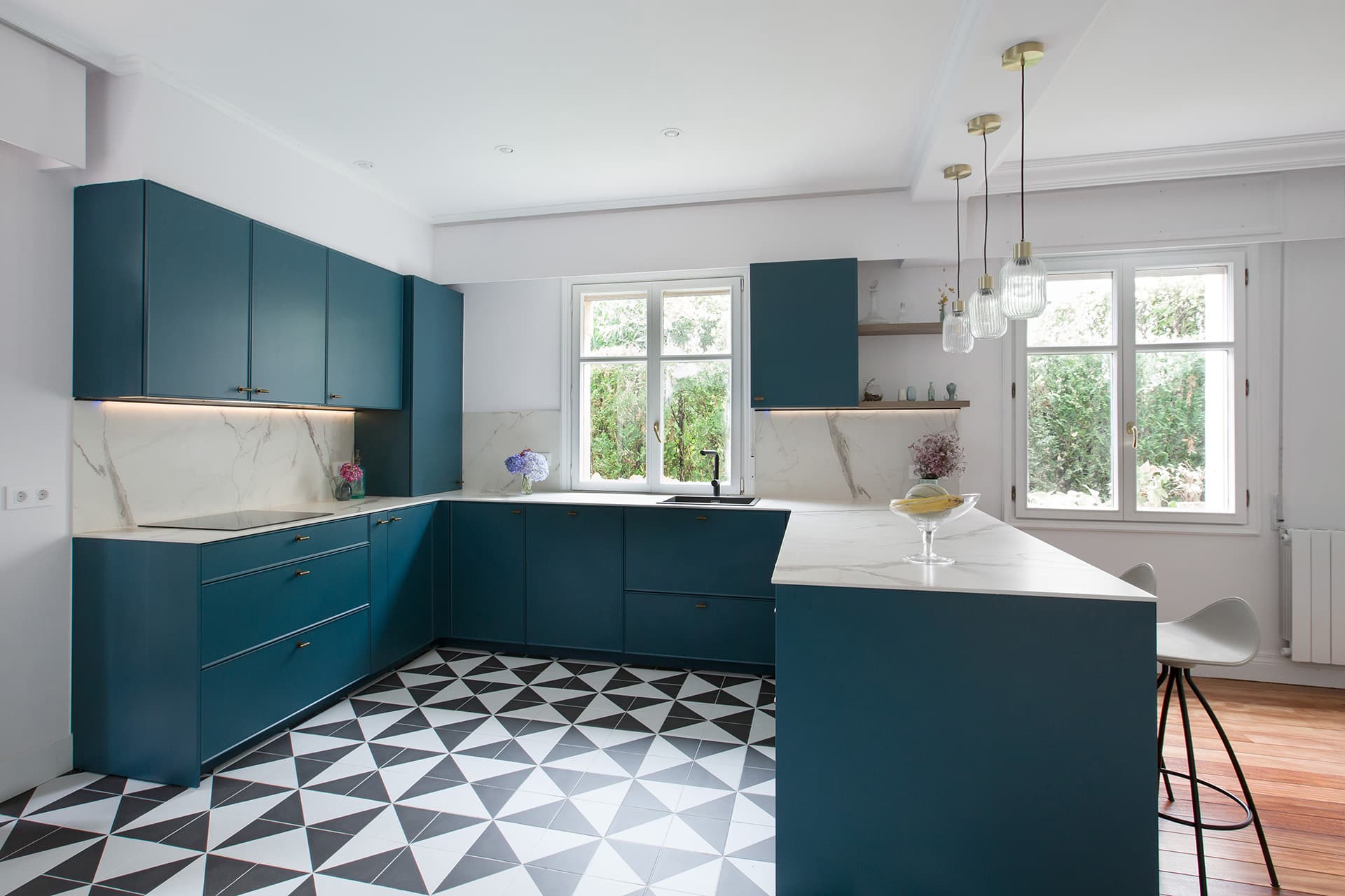 U-shaped blue kitchen with white worktop in a Santos Kitchens project.