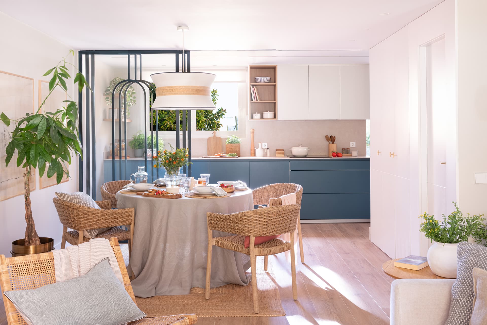 Blue and white kitchen open to the lounge designed by Santos Kitchens.