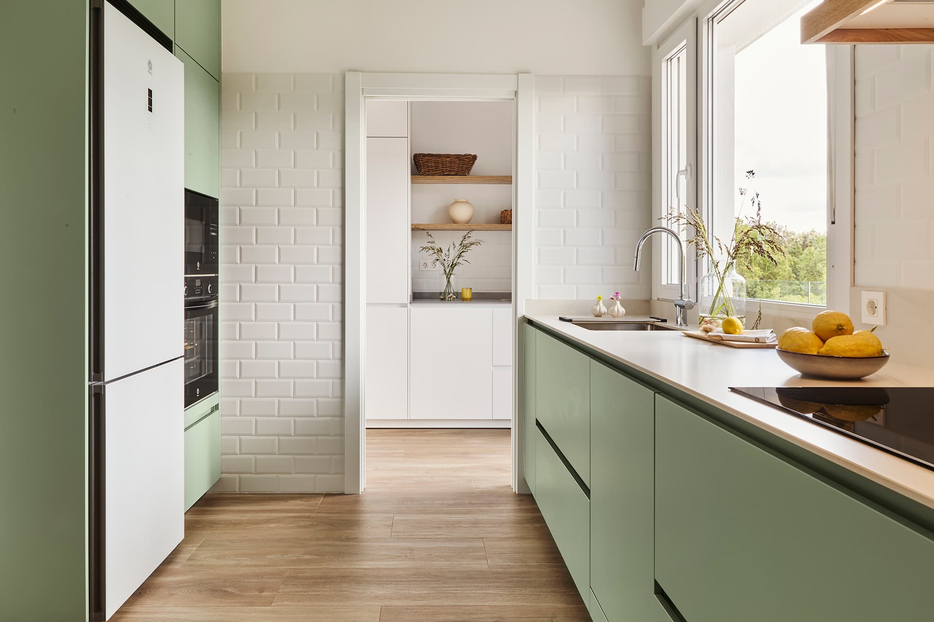 Green kitchen with parallel layout designed by Santos Kitchens.