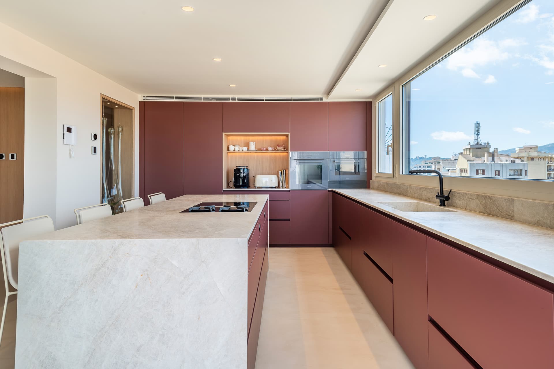 Red kitchen with island designed by Santos Kitchens.