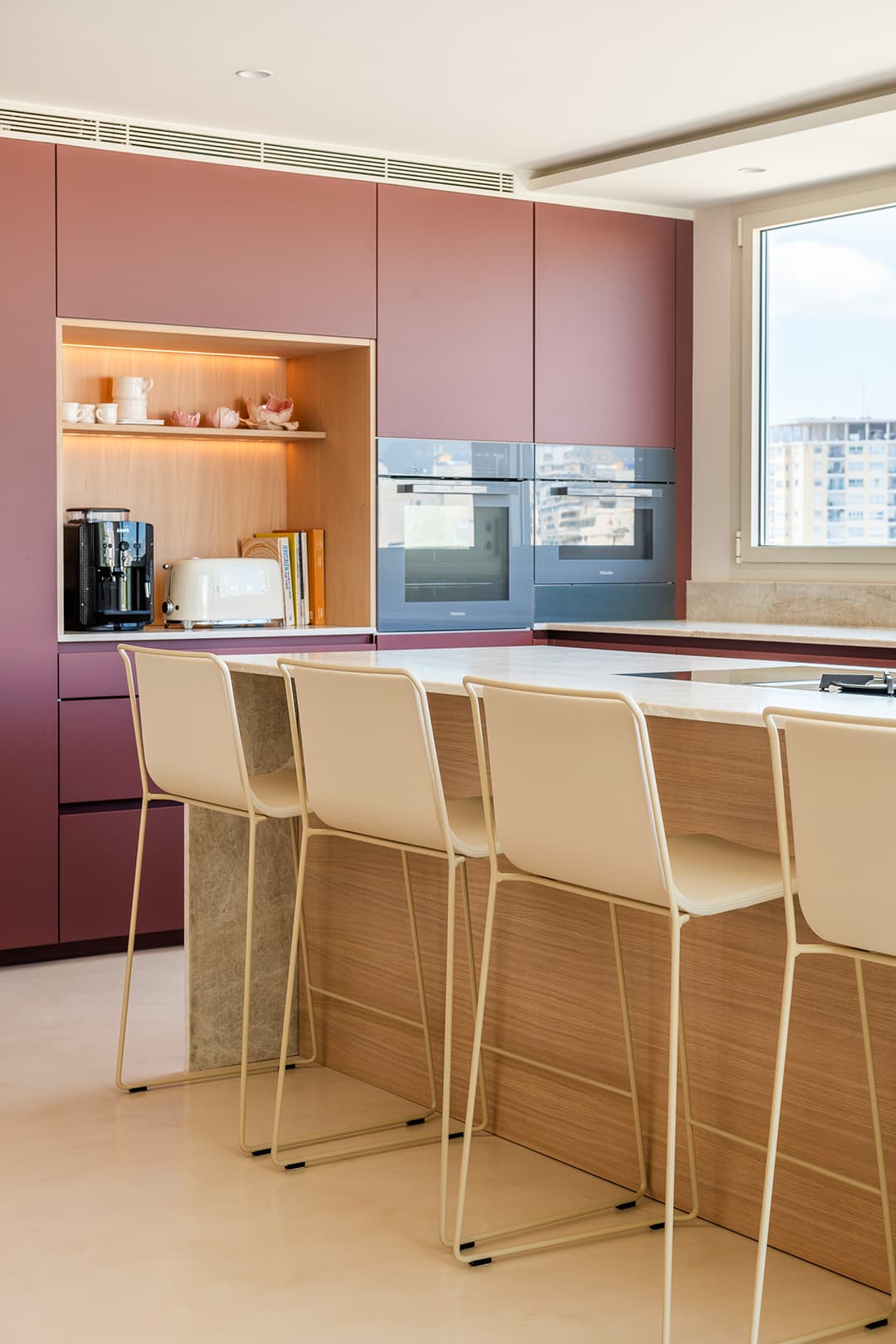 Red kitchen with centre island and stools designed by Santos Kitchens.