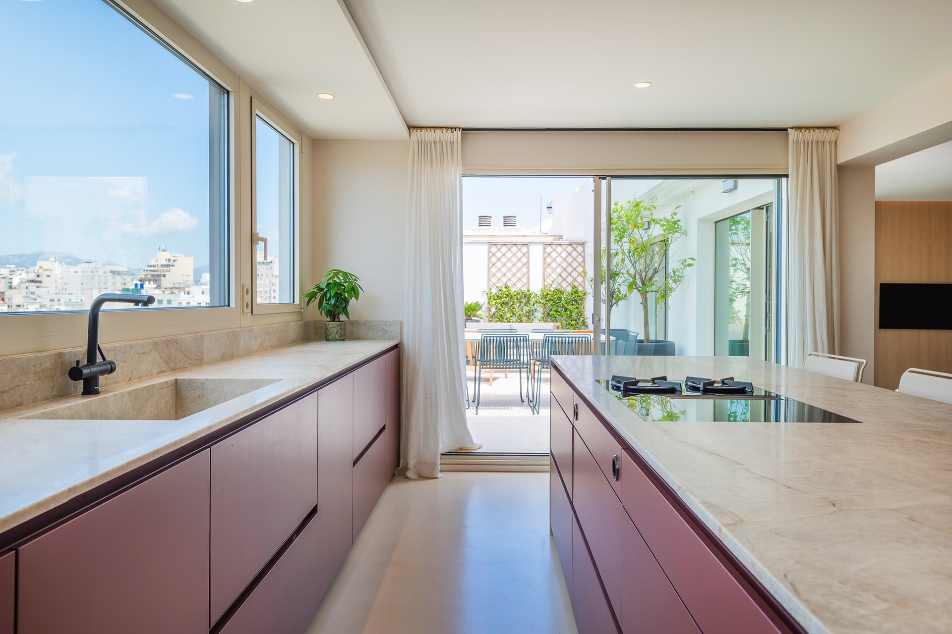 Red and kitchen open to a terrace in a Santos Kitchens project.