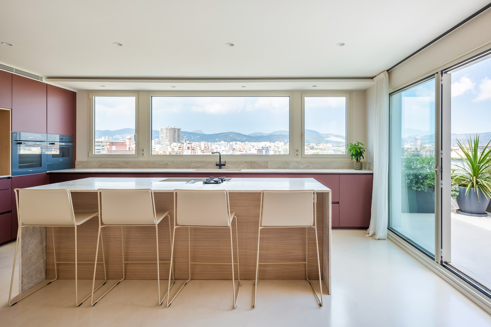 Red and white kitchen with centre island designed by Santos Kitchens.
