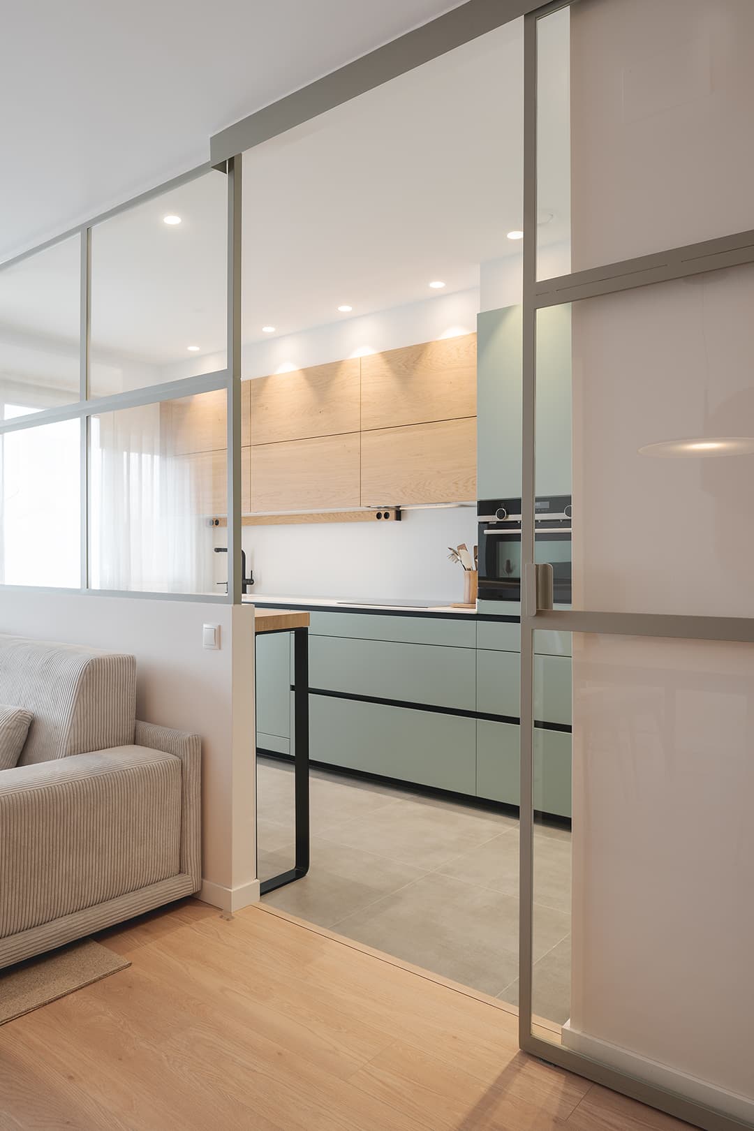 Green kitchen with glazed enclosure designed by Santos Kitchens.