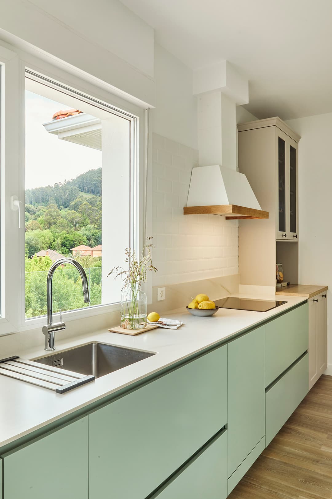 Green kitchen with white worktop designed by Santos Kitchens.