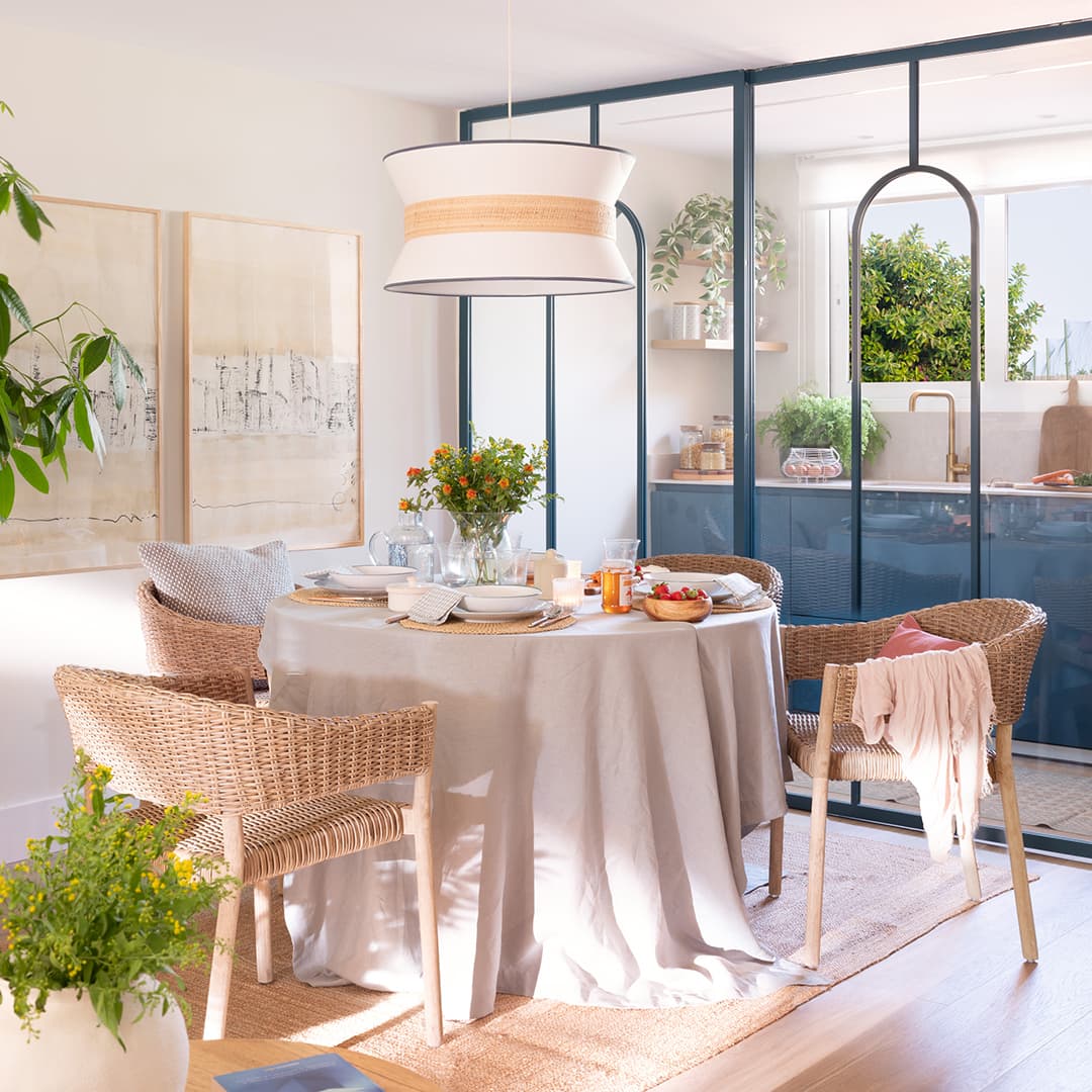 Diner in an open-plan kitchen with glazed enclosure by Santos Kitchens.