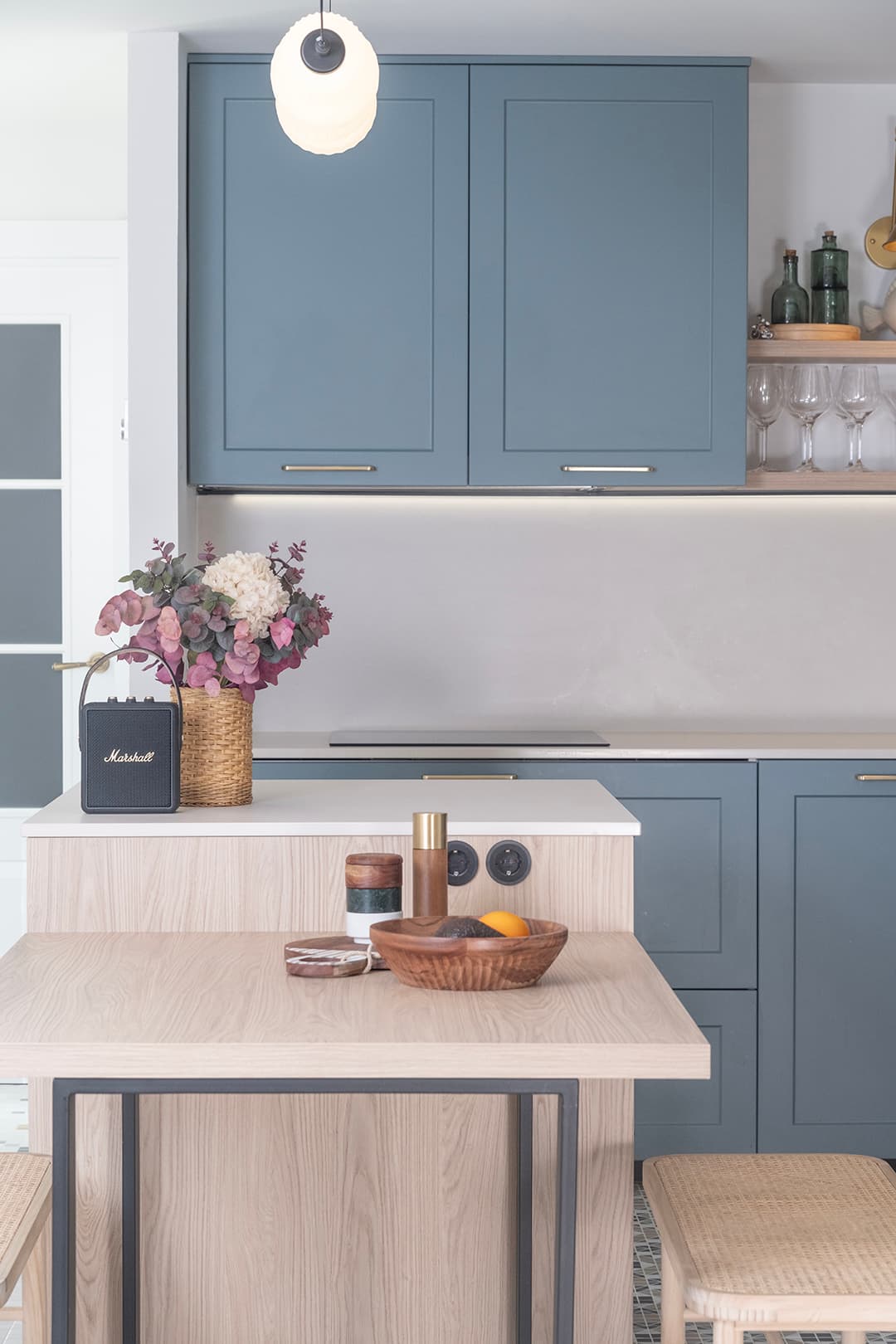 Close-up of table and worktop in a blue kitchen designed by Santos Kitchens.
