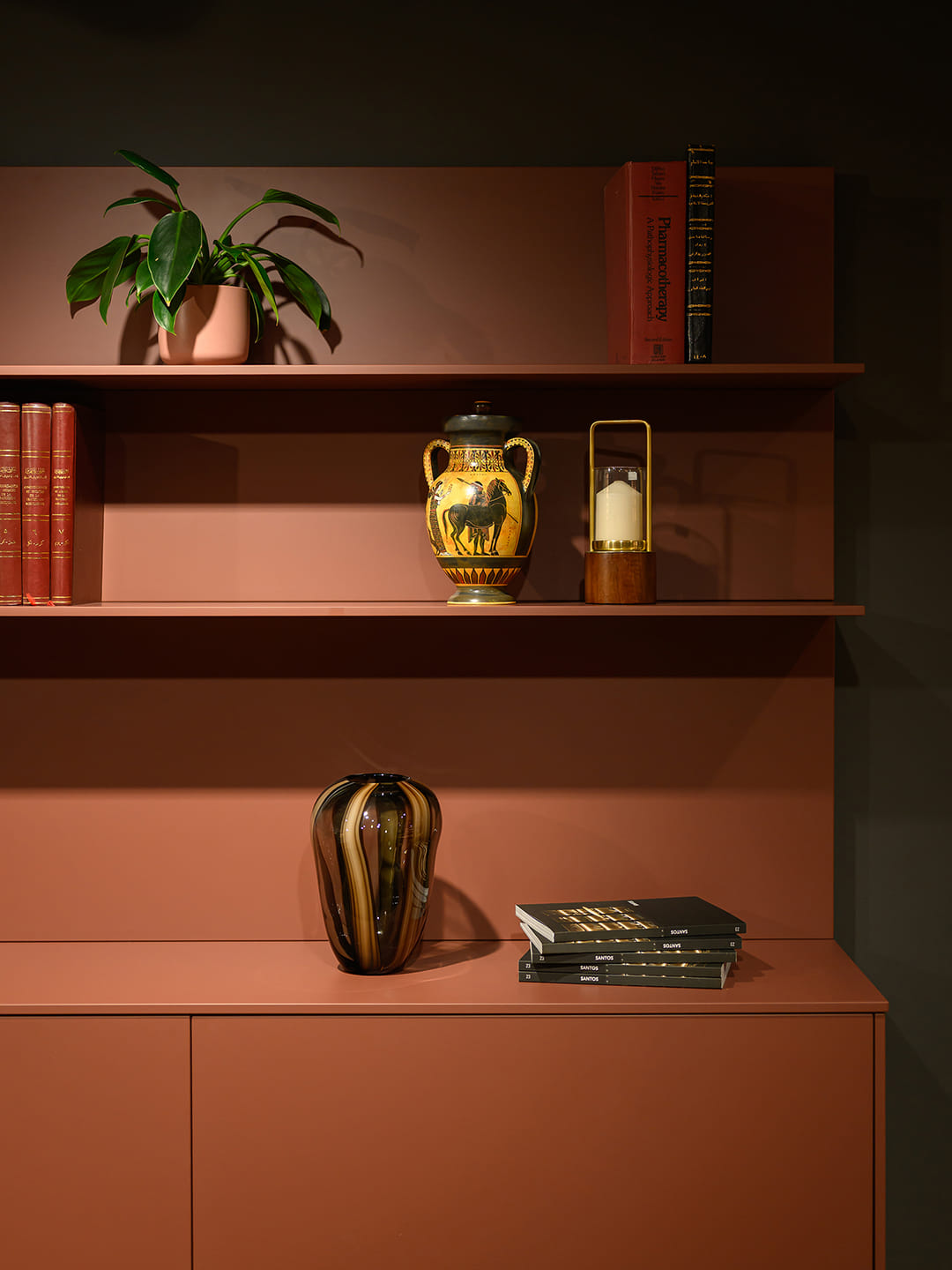Wall-mounted shelves and drawer units in red at the eba Riyadh showroom.