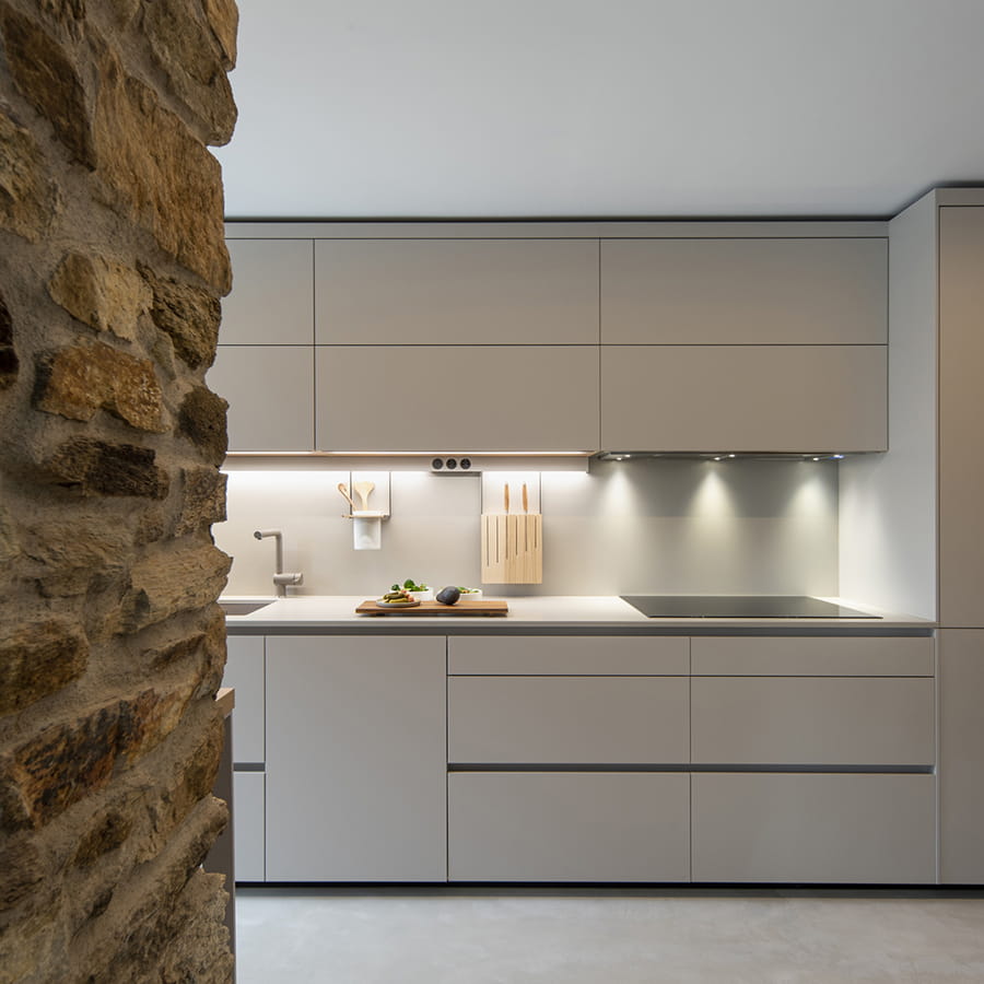 Front of a Cashmere Santos kitchen open to the lounge area.